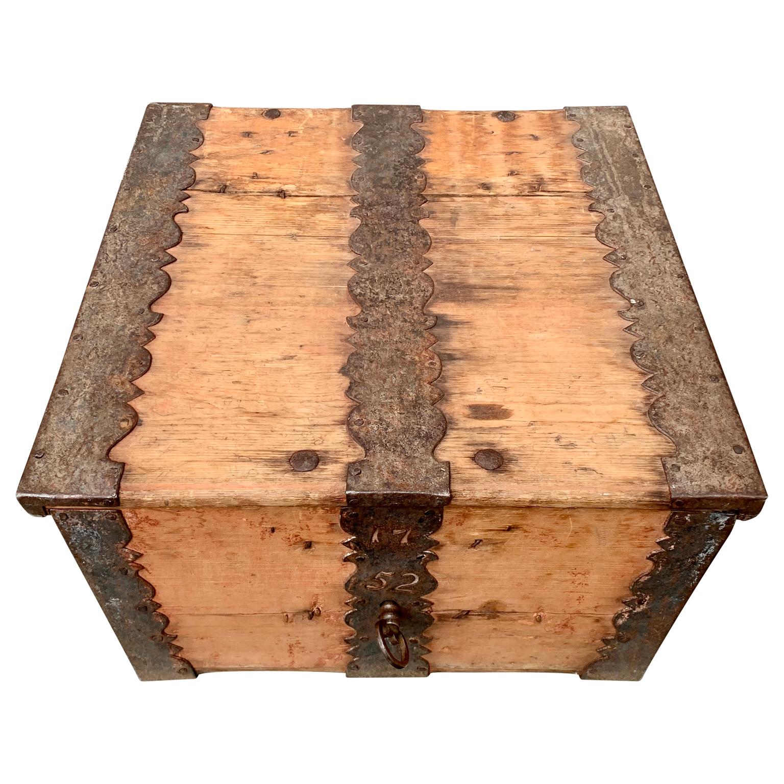 A Swedish Baroque box with original ironwork, key and big strong perfectly working lock dated (forged in the iron) 1752. This special shaped pine wood box,  bought in the region of 