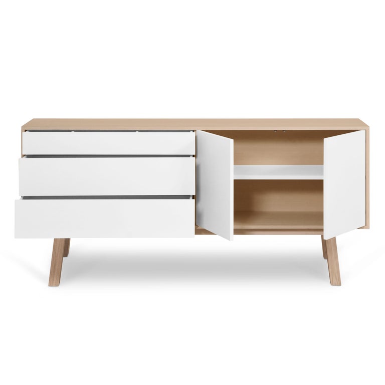 This 2 doors and 3 drawers sideboard is designed by Eric Gizard - Paris.

It is 100% made in France with solid ash wood, veneer and lacquered doors in MDF panels. 

The 2 doors open with a 