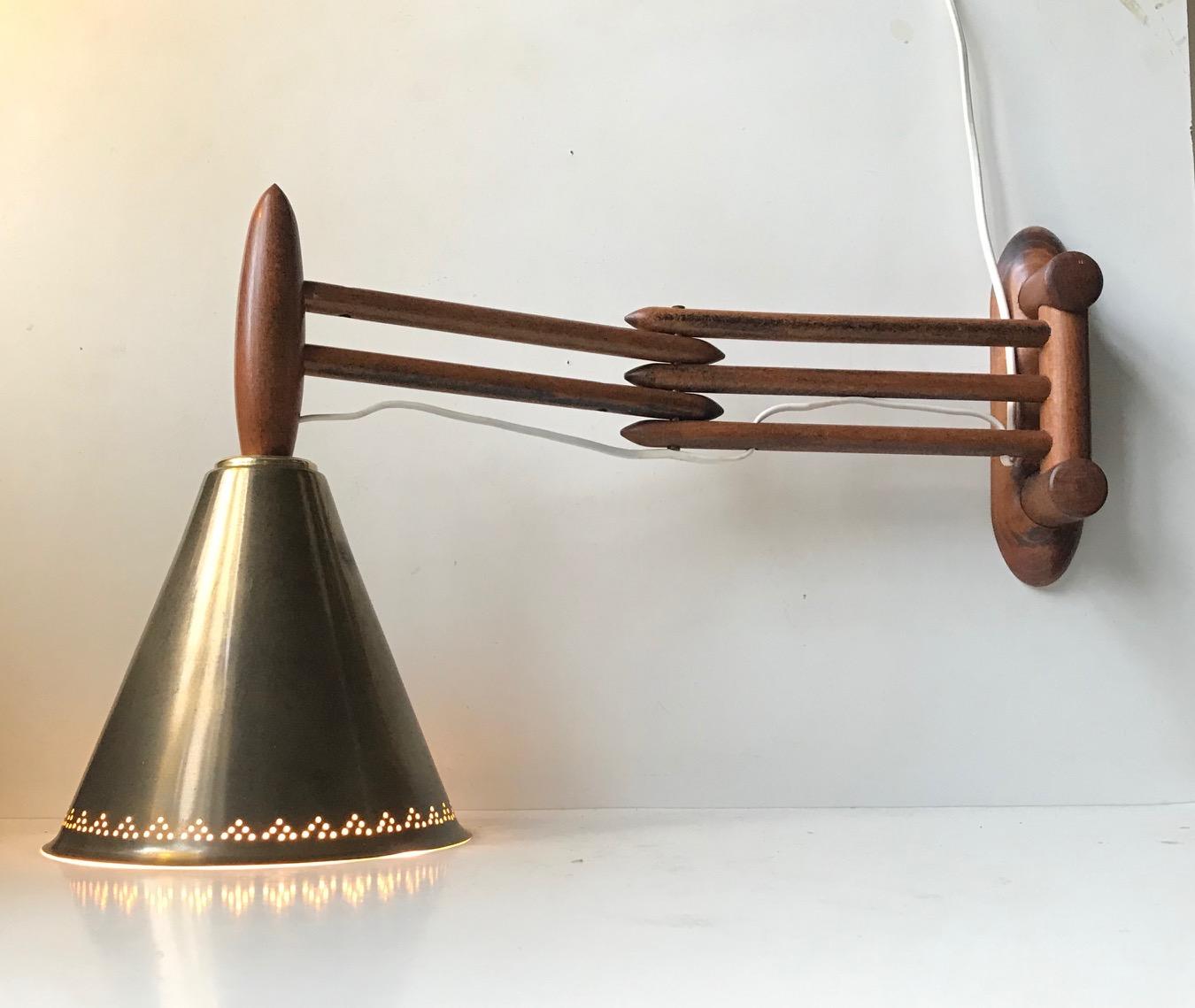 Unusual dept adjustable (up to 57 cm) Accordion wall light made from teak and mounted with a conical solid brass shade. We doubt that the lamp was made this way originally, but the shade and expandable arm suits each other tremendously. However its
