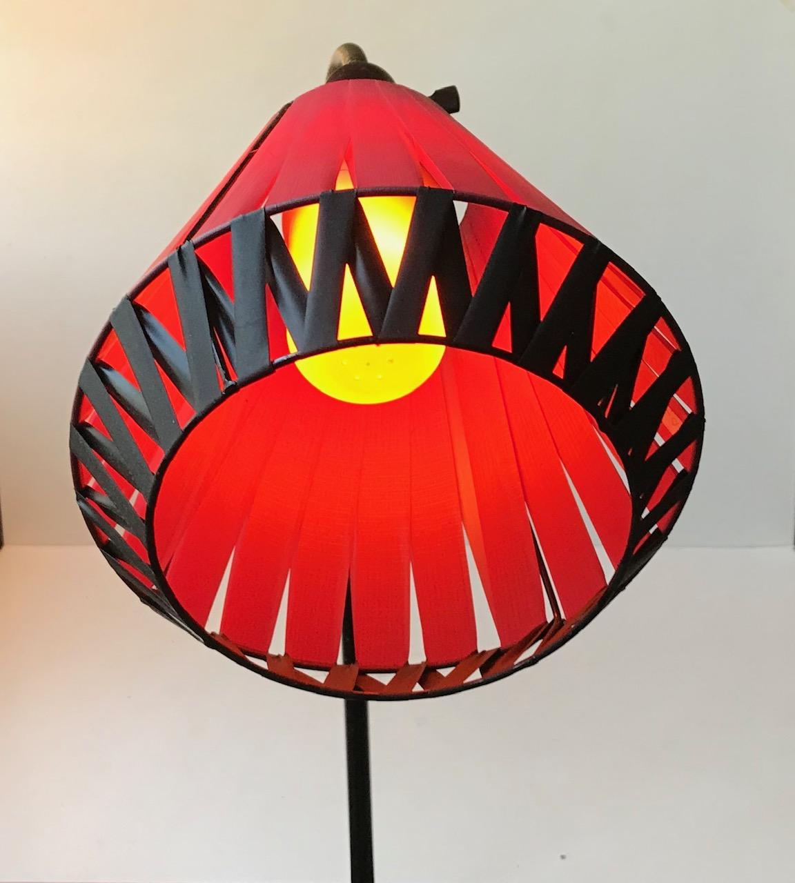 Original 1950s floor lamp featuring red/black textile wrapped shade, flexible brass gooseneck, easy accessable on/off switch at the shade and a asymmetrical base with brass accents. Anonymous Scandinavian maker circa 1950 in the style of Svend Aage