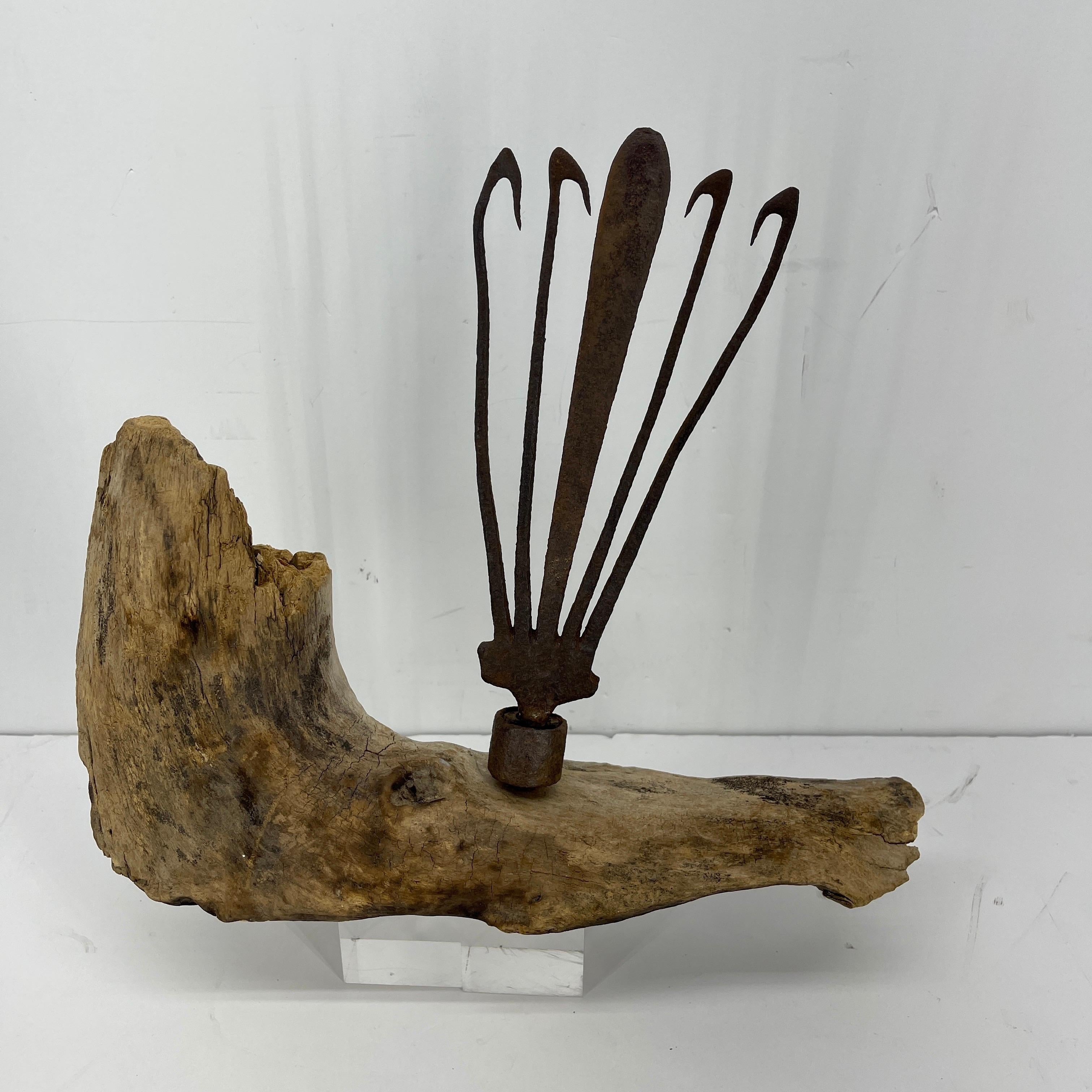 Antique wrought iron eel fork mounted on driftwood base.
Hailing from Denmark, this highly unusual antique wrought iron eel fork is mounted on sturdy piece of driftwood. As a desk accessory or an accent piece on a bookcase, this is a statement