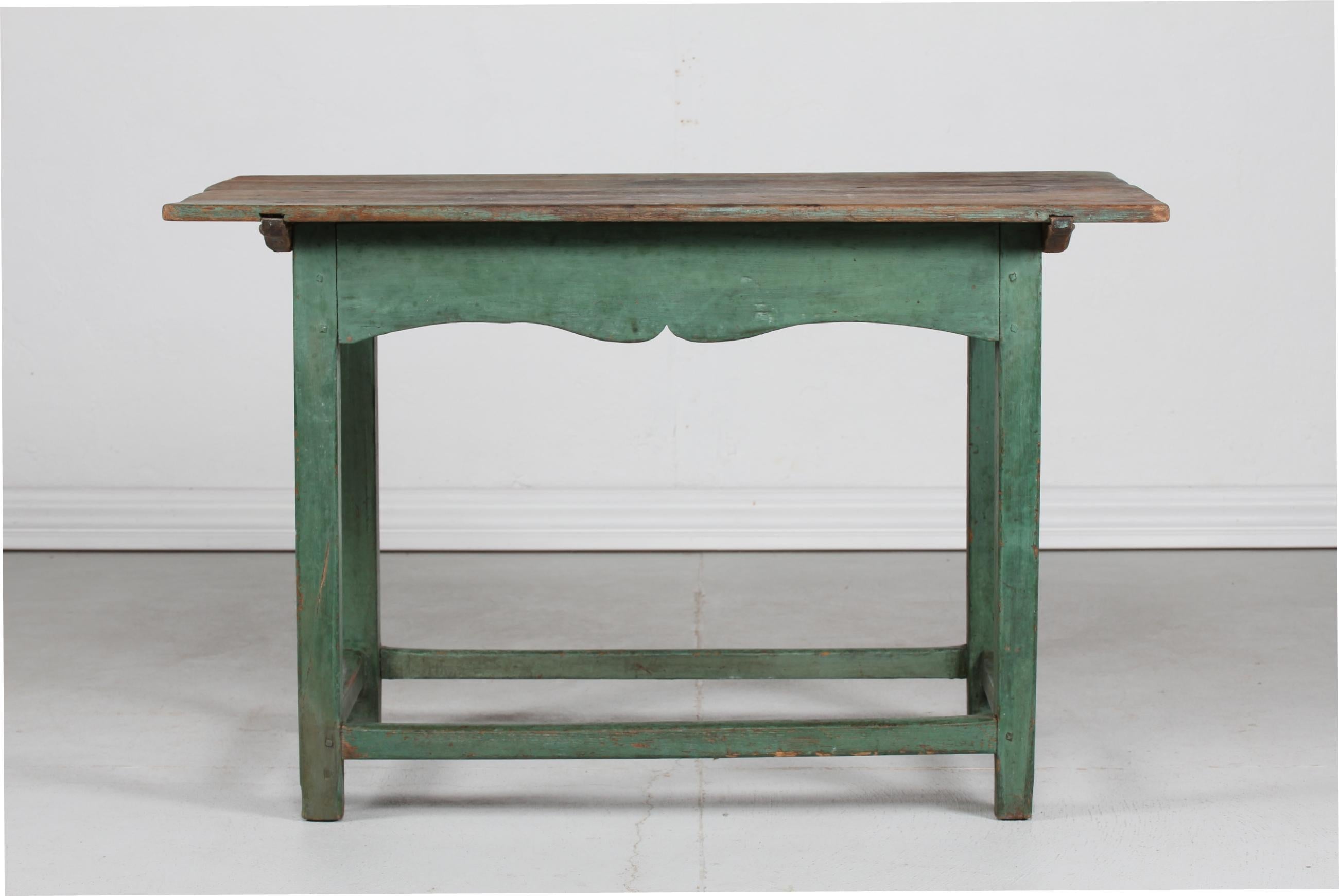 Antique Scandinavian country side working table from the 19th century made of pine wood. 
The frame of table is hand painted with matte green paint with great patina 
and the paint on the top has been worn off through many years of