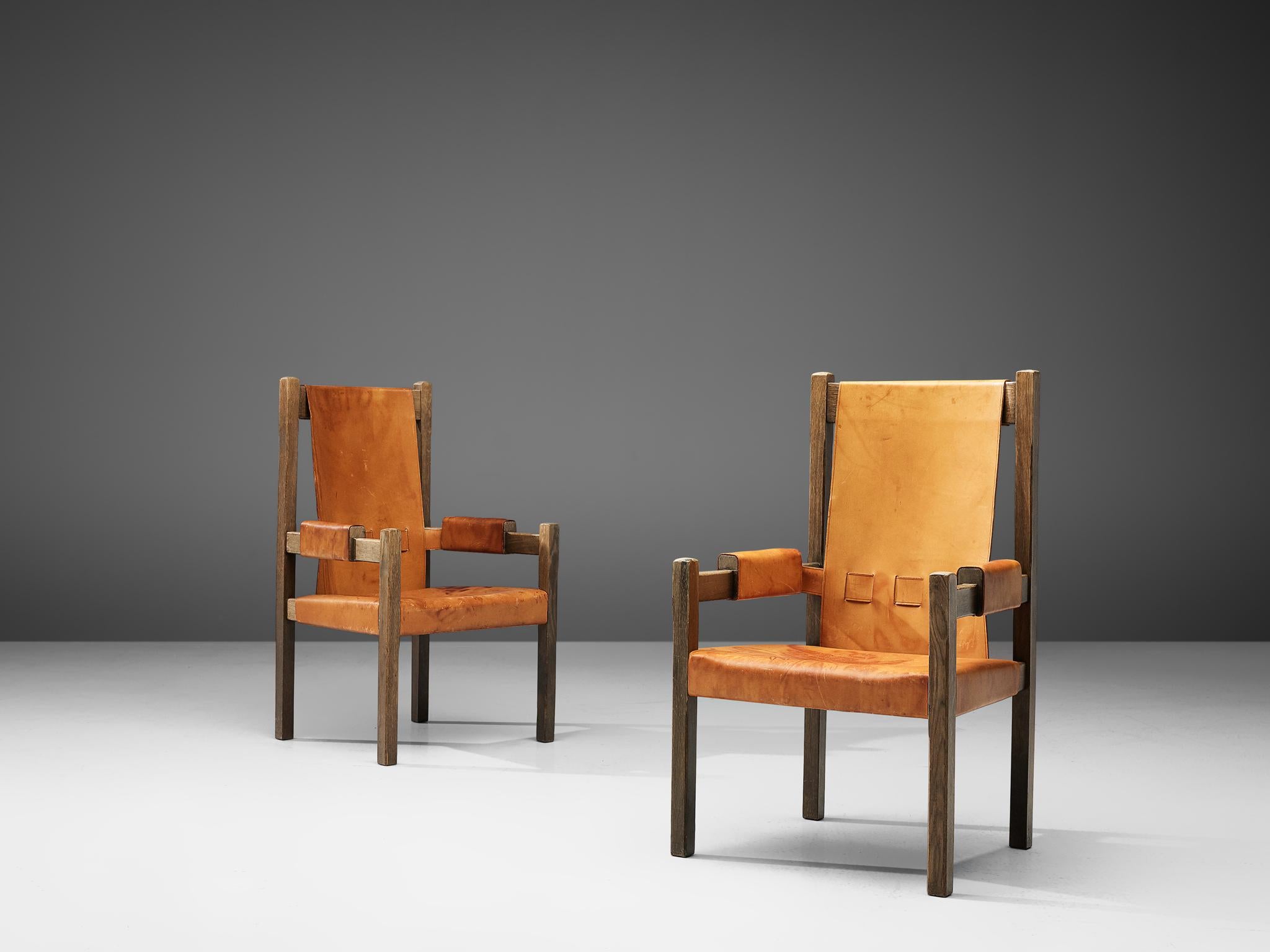Pair of highback chairs, leather and wood, France, 1960s

Cognac leather armchairs with a highback and wooden fraes. Throne inspired design with angular shapes. The leather is strained on the seat and backrest, while the leather armrests are
