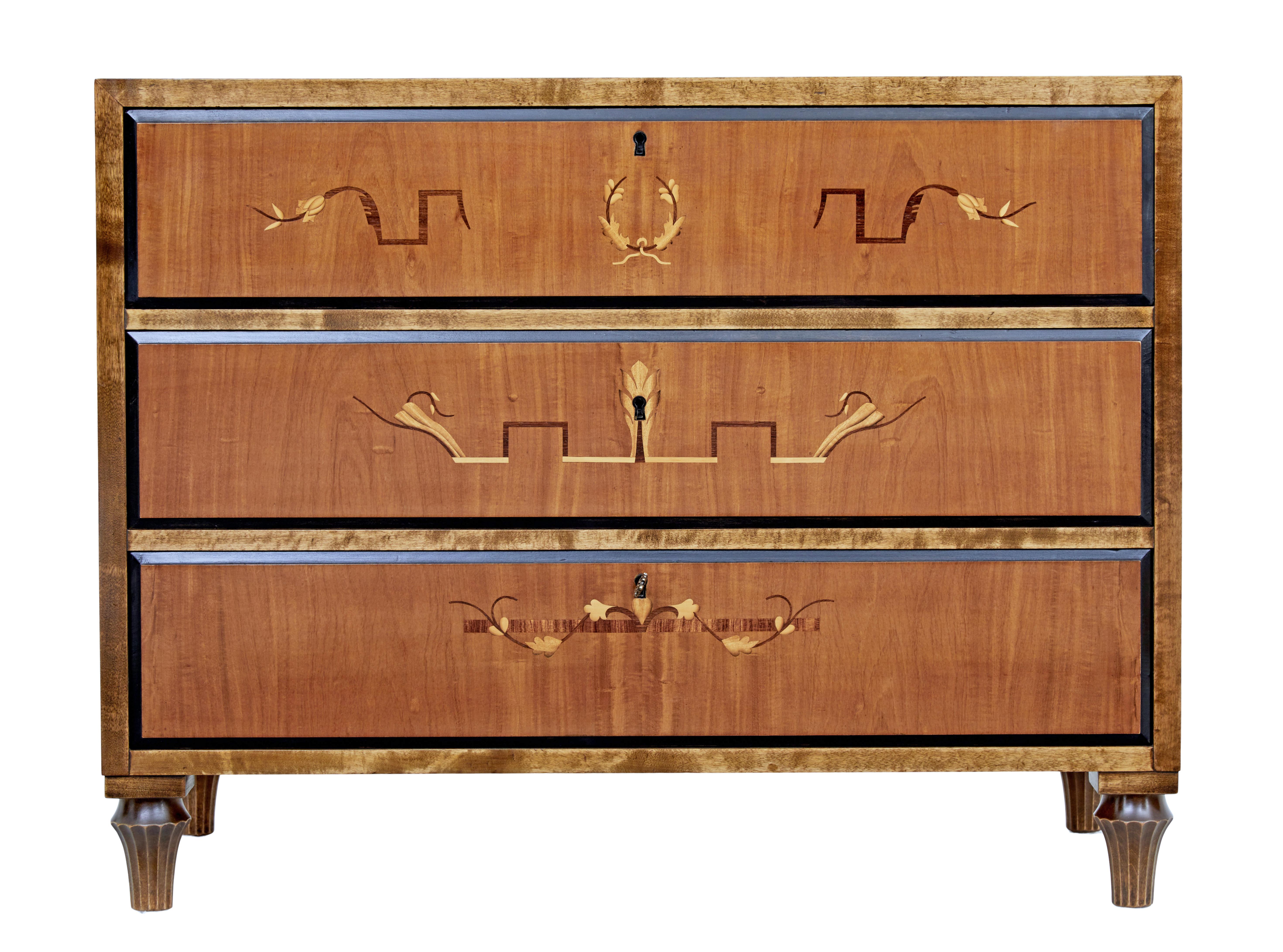 Scandinavian Art Deco inlaid chest of drawers, circa 1930.

Elegant period deco chest, fitted with 3 drawers that open on the key. Inlaid with motifs to the drawer fronts, with ebonized outer edge. Rich birch top and sides.

Standing on fluted