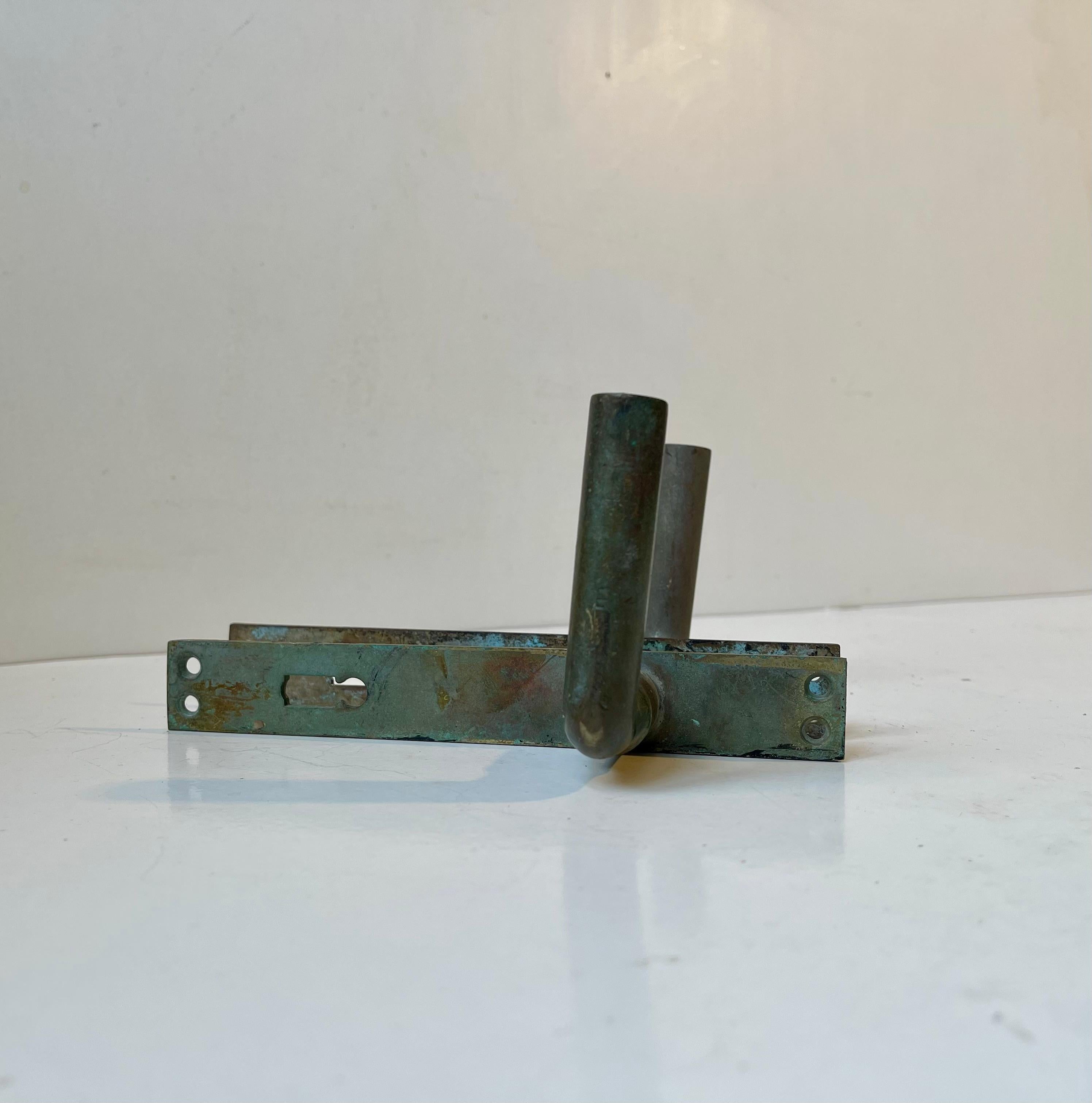 6 Door handle sets with lock/key covers in patinated metal/brass. The solid brass spindles are patinated differently and rounded of softly due to excessive use over the years. Suitable for your office, conservatory, Atrium, bathroom etc. They were