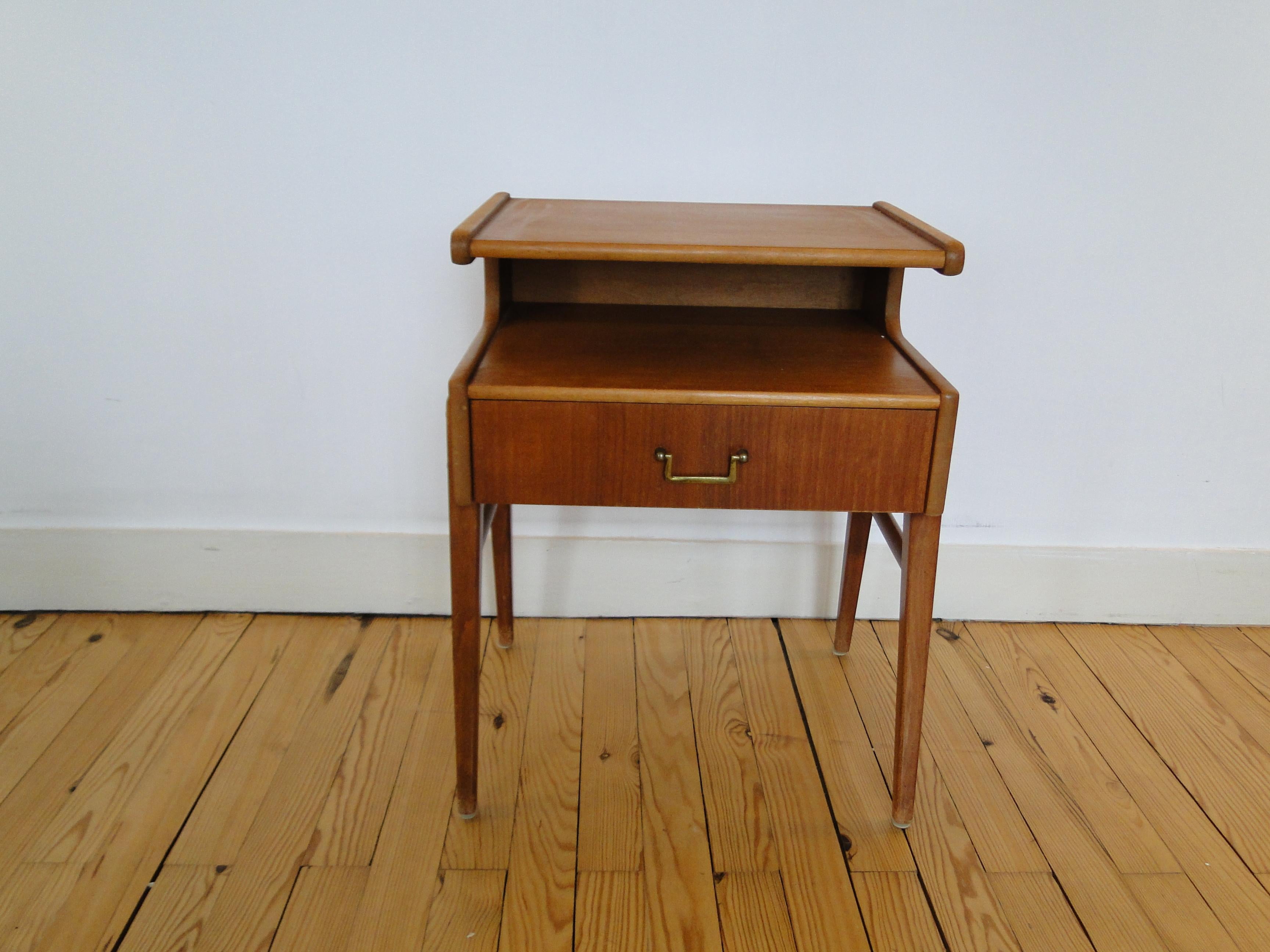 Scandinavian teak bedside table with drawer and brass handle. 
Magazine rack and shelf.
Very good condition.