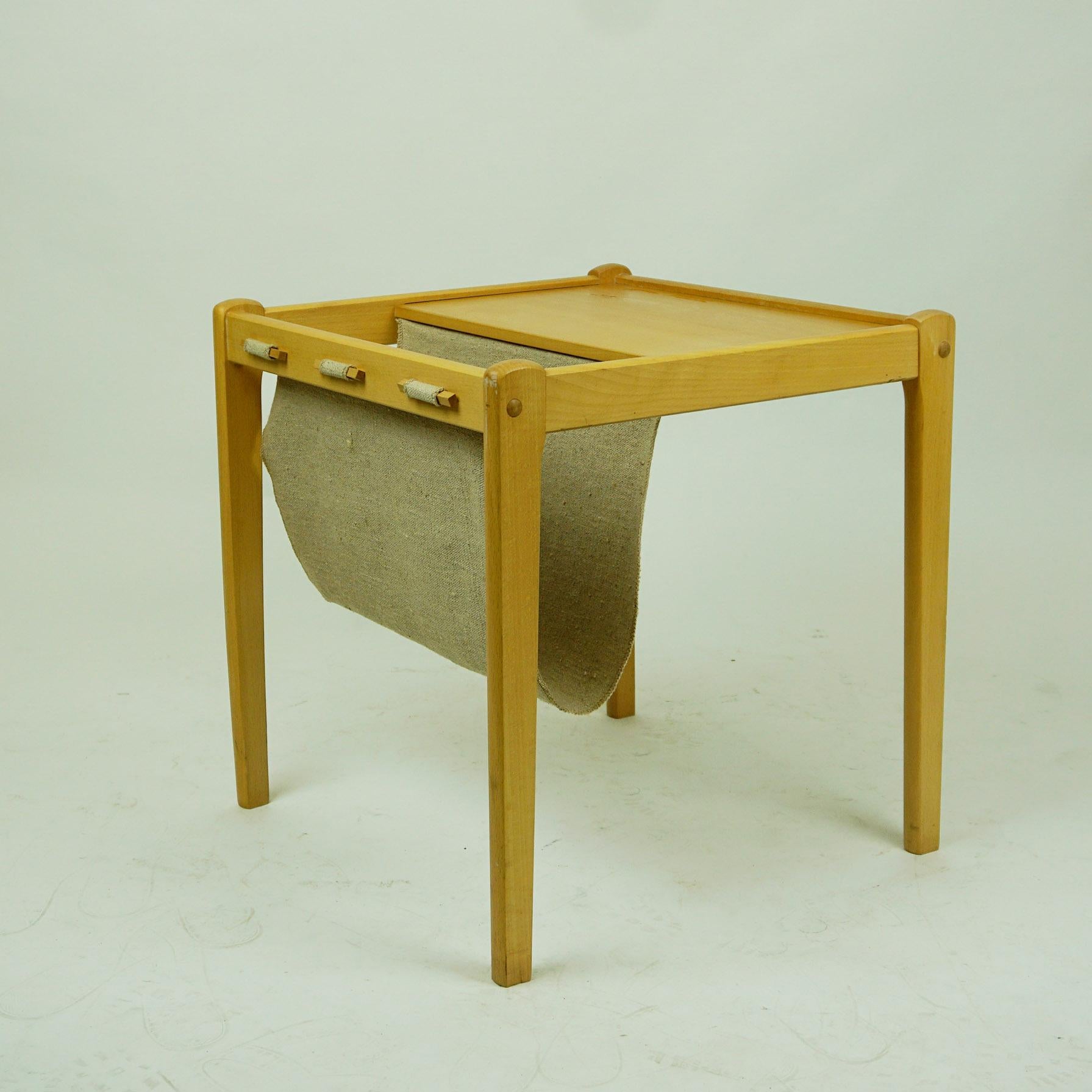 Small charming Danish 1960s bright beechwood side table with integrated linen magazine holder by BRDR Furbo, Denmark. On its underside it is brand marked Made in Denmark. Fantastic and ready to use addition to any modernist interior!