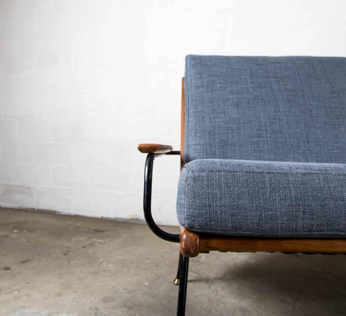 Scandinavian bench with metal and wooden base.
The pillows are reupholstered in blue linen.