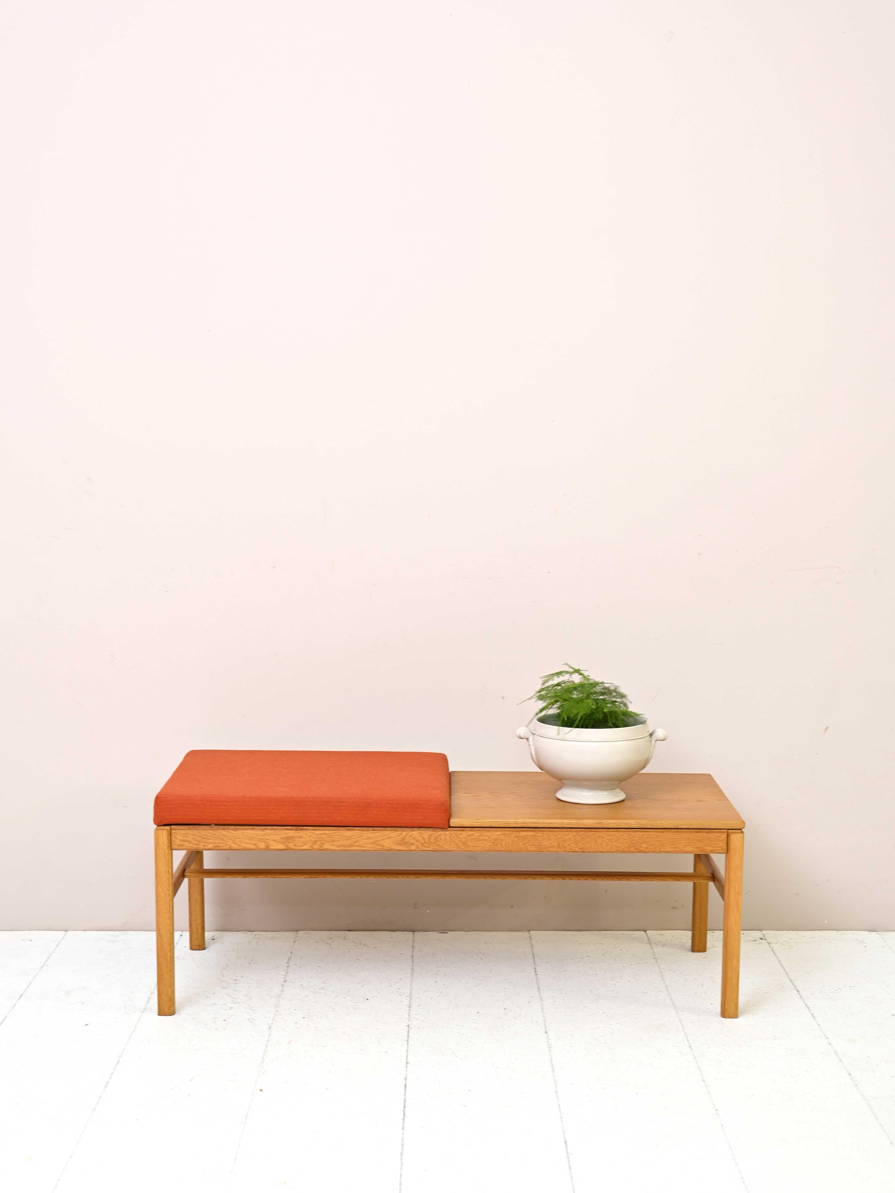 Swedish oak bench from the 1960s.

This original piece of furniture with simple and modern forms is distinguished by the presence of the upholstered seat covered with original orange fabric.
A piece of furniture with vintage warmth and