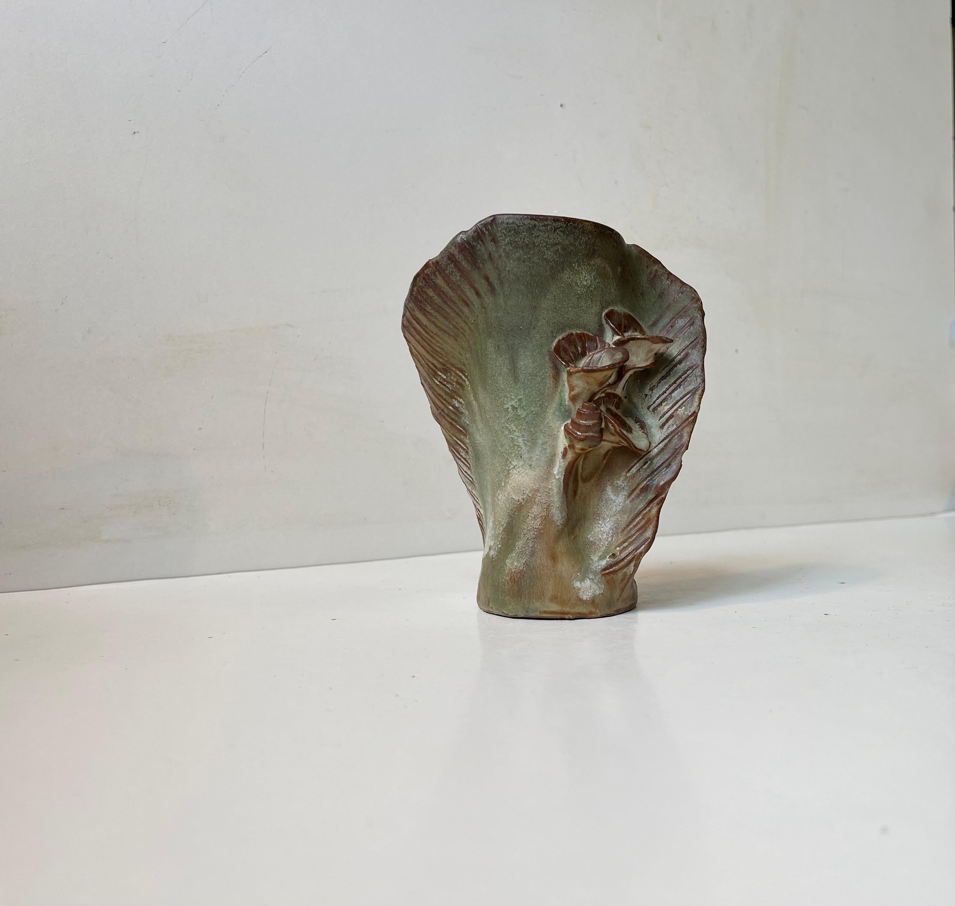 Kristofle Handmade biomorphic vase in the style of Arne bang. Floral dekoration upon a cobra shaped body in earthy green and brown glazes. Signed to its side by the Scandinavian artist. Measurements: H: 15 cm W: 12/11 cm, Dept: 8 cm.