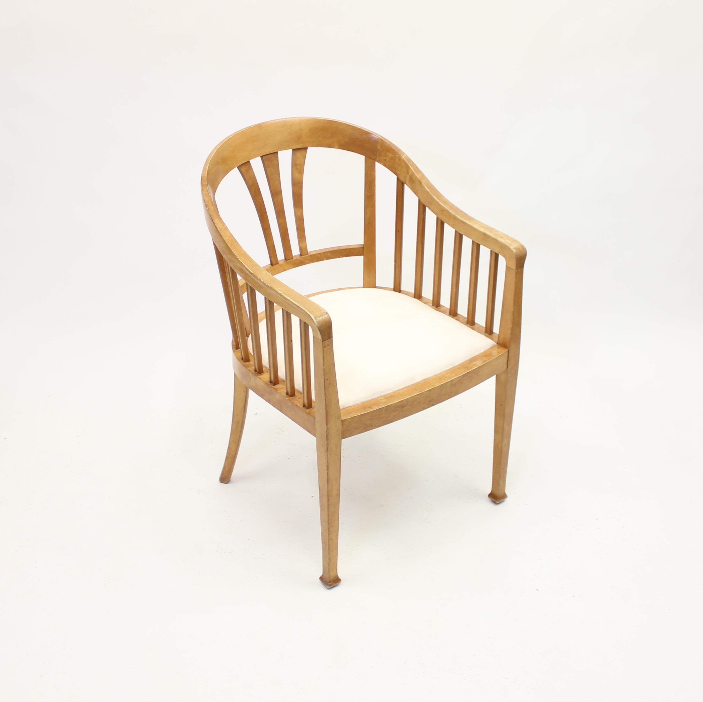 Art Nouveau arm chair in birch with new off white alcantara fabric to the seat. Most likely Swedish and made in the early 20th century. Good vintage condition with light ware consistent with age and use.