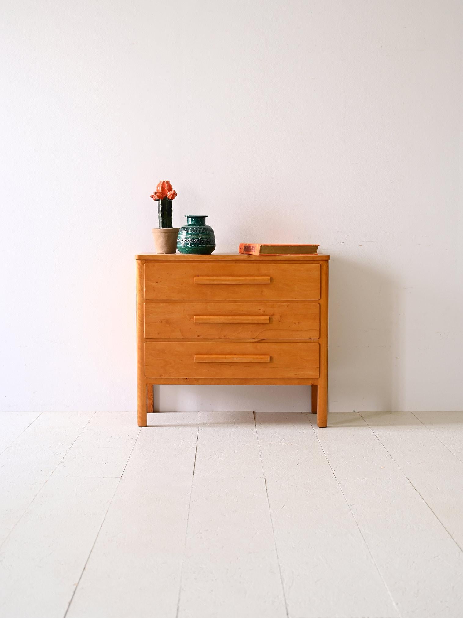 Original vintage 1960s Nordic chest of drawers.

This birch wood chest of drawers is an elegant fusion of Nordic design and practical functionality. Its solid construction features squared legs that recall classic mid-century style, lending a touch
