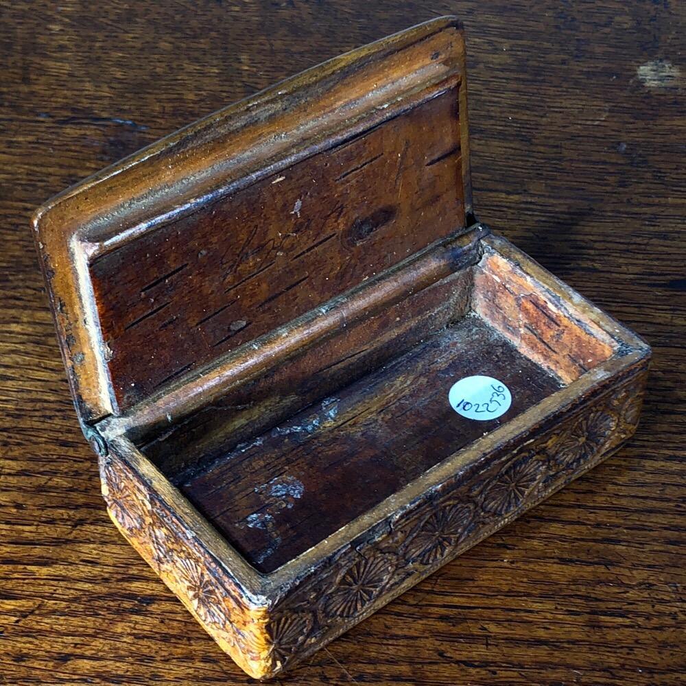 Scandinavian birchwood box, with carved and compressed sides and top, the sides with a strip of flower embossed bark, the top with a hunt scene with a stag trampling a hunter, a dog in close pursuit.
An indistinct name inside the lid,
19th century