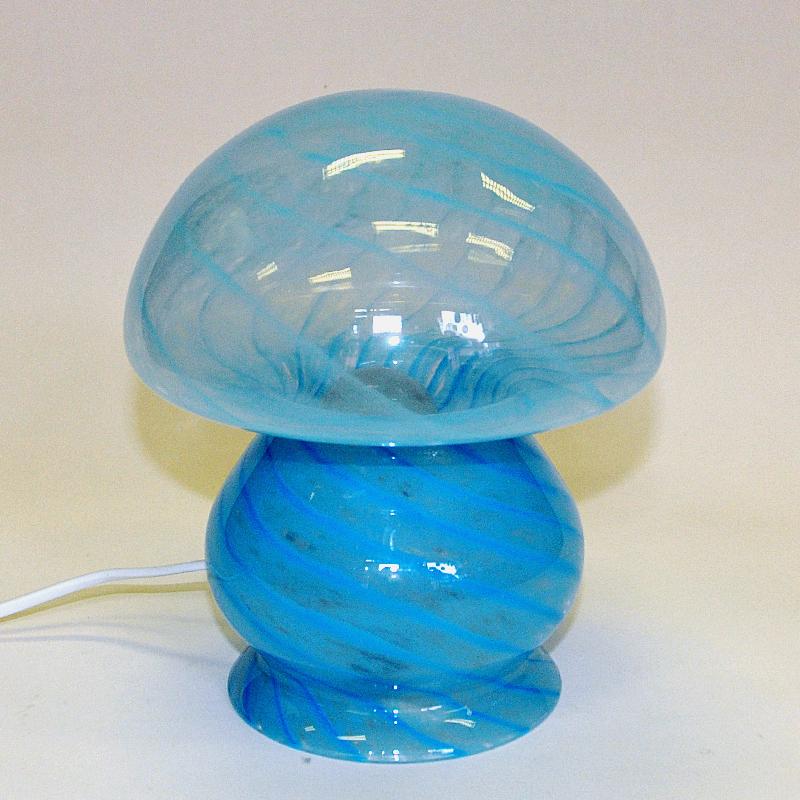 ﻿Lovely and blue decorative Scandinavian mushroom glass tablelamp from the 1970s. A mushroom shaped transparent glass lamp with light blue and darker blue stripe patterns. Made in one whole piece with a white cord with light switch. Gives a great