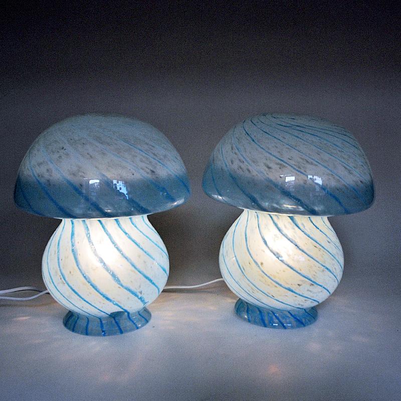 ﻿Lovely and blue decorative pair of two Scandinavian mushroom glass tablelamps from the 1970s. Mushroom shaped and transparent glass lamps with light blue and darker blue stripe patterns all over. Made in one whole piece with a white cord and light