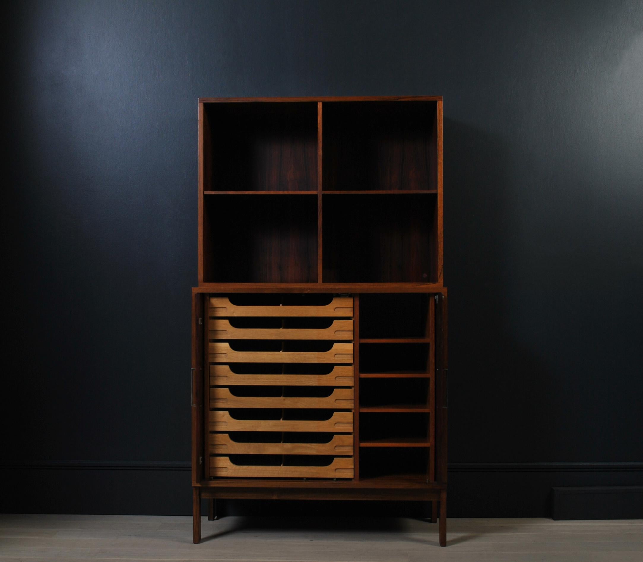 A Danish Midcentury Rosewood tall bookcase with beech drawers and adjustable shelves to lower cabinet. The doors cleverly open and slide away into the sides. Produced by SB Mobler in 1967. The top bookcase unit can be lifted off and used totally
