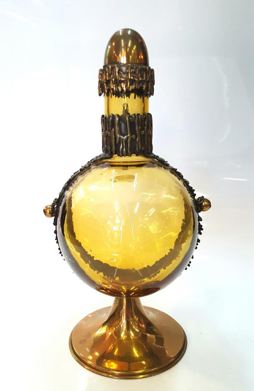 Designed by Pentti Sarpaneva, Finland, this signed piece features a hand blown colored glass body with patinated brass accents. From the 1960s, this piece is in great condition. Stamped, signed on the side.