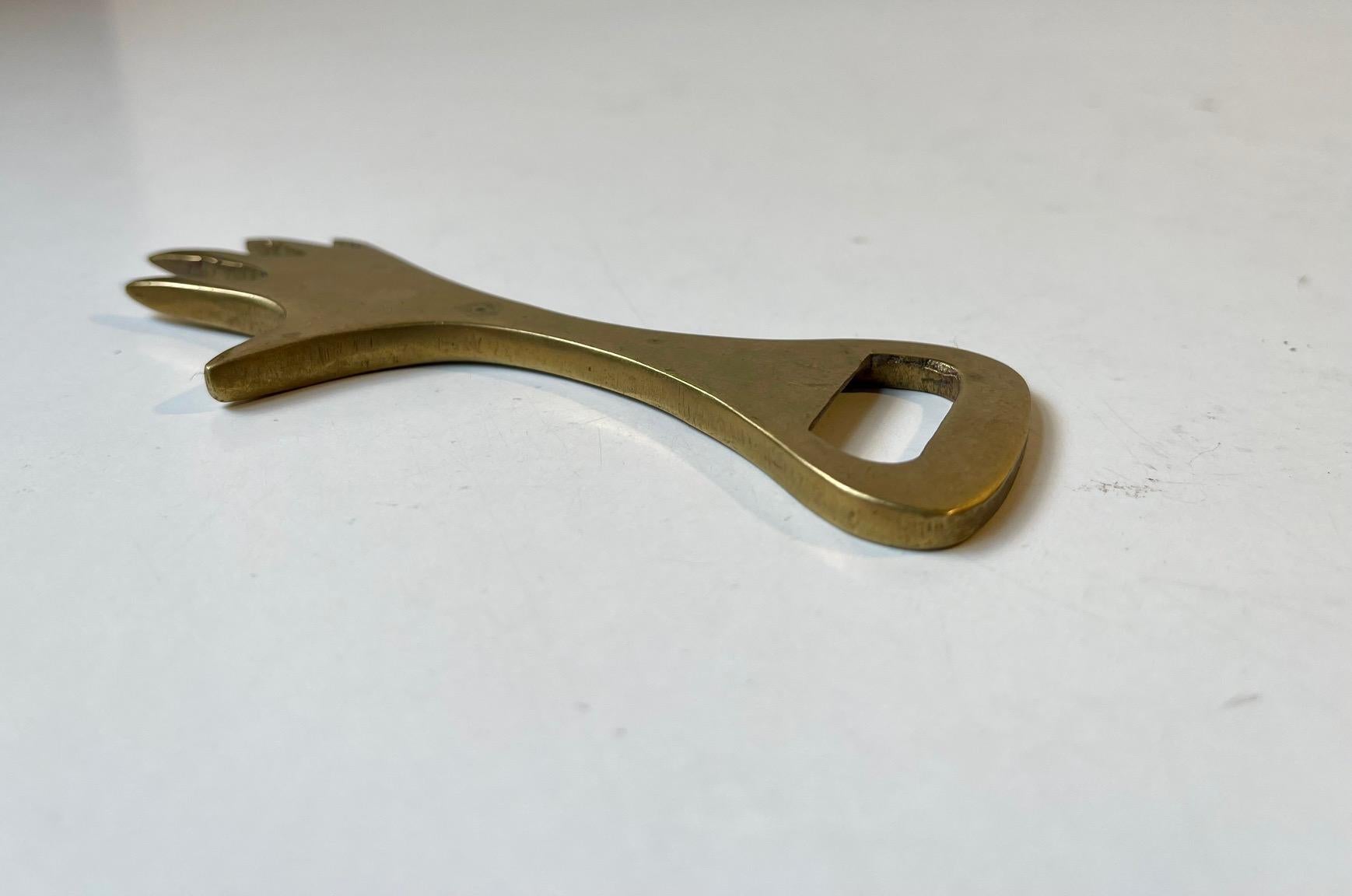 A vintage bottle opener in the shape of a female hand. Its executed in solid brass. Originally sold at Illums Bolighus in Copenhagen during the 1950s. It may have been manufactured by Wiener Werkstatte in Austria but it has no markings.