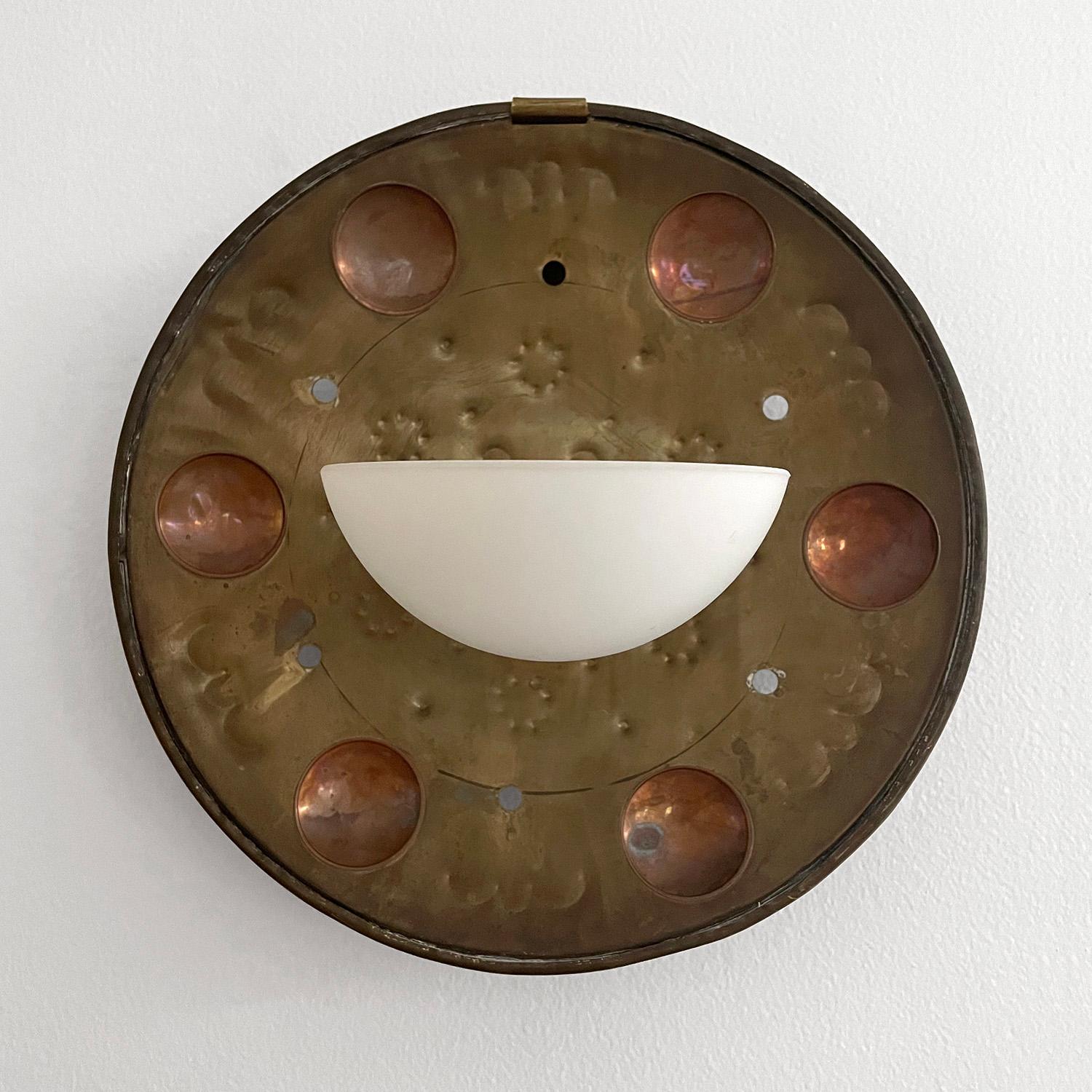 Scandinavian brass & copper wall sconce
Handcrafted rustic brass sconce with copper accents
Frosted milky glass shade has a small flea bite on the interior around the light socket 
Not visible when installed, please reference photo 
Patina from