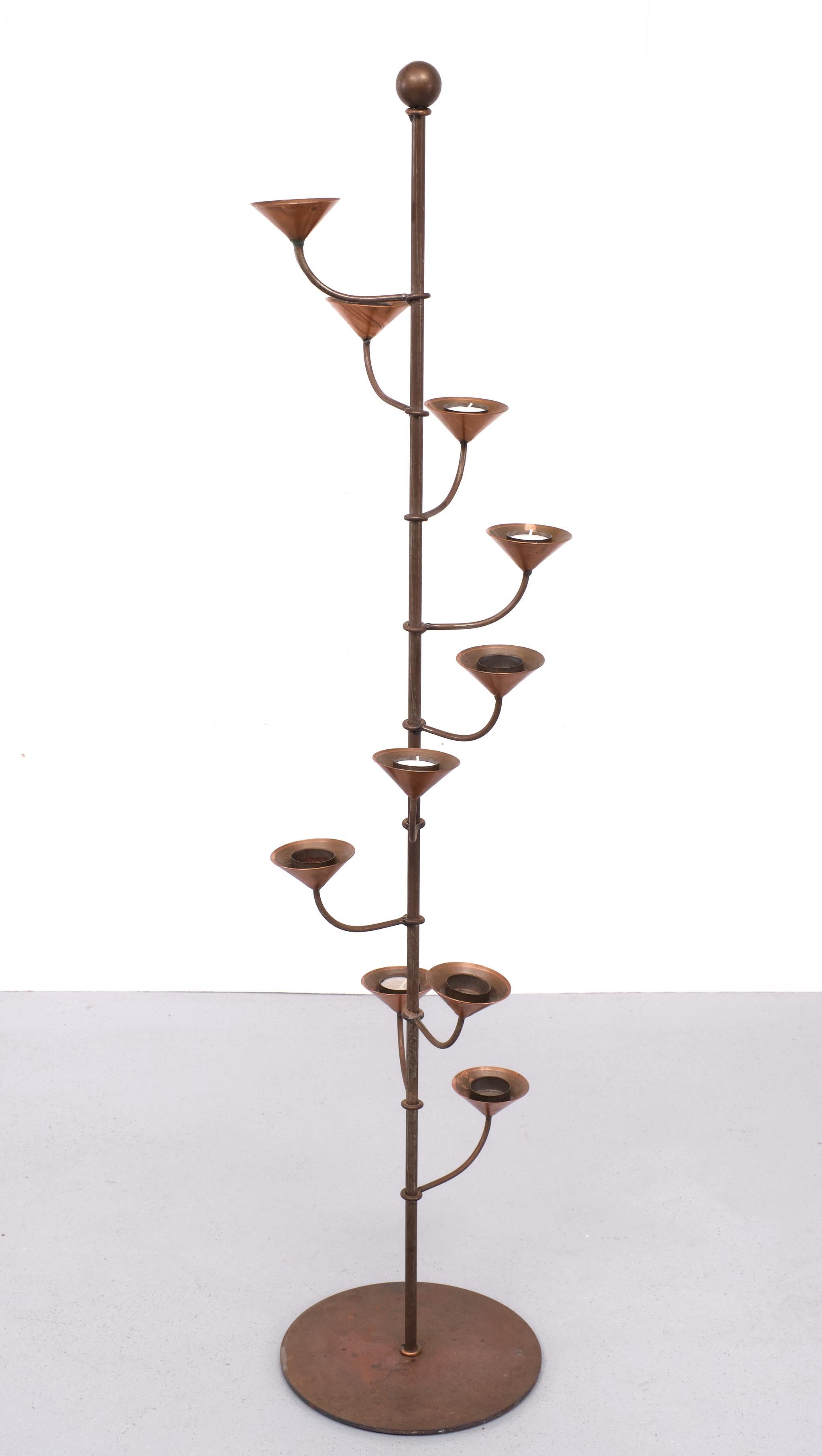 Very nice Mid Century modern standing candle stick . Ten candle holders 
For Tea Lights or others . Hand forged Steel upright ,comes with cone shaped Copper candle holders . So decorative .

Please don't hesitate to reach out for alternative