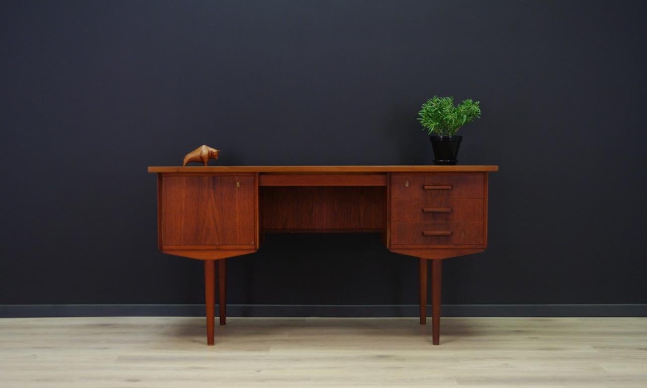 Stylish desk from the 1960s-1970s, Minimalist Danish design, perfect in every detail. Desk veneered with teak, original handles. It has three drawers at the front and a bookshelf at the back. It also has a key. Preserved in good condition (minor