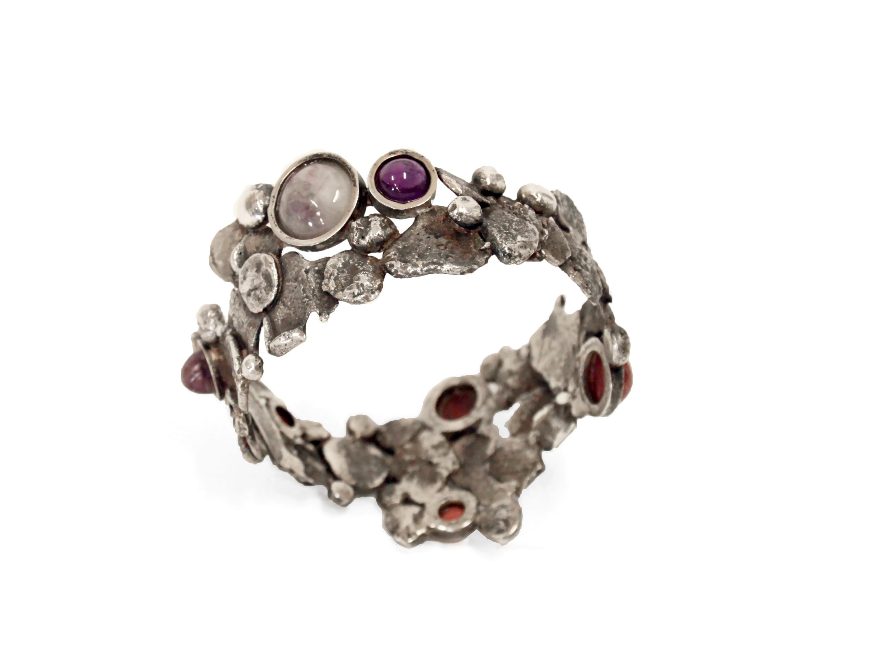 Wonderful and unique silver bracelet with tourmaline stones. Designed and made in Norway by Konrad Mehus ca 1973.

Konrad Mehus is a Norwegian jeweler who is a true pioneer in Norwegian jewelry art. By combining jewlery and sculpture in his works,