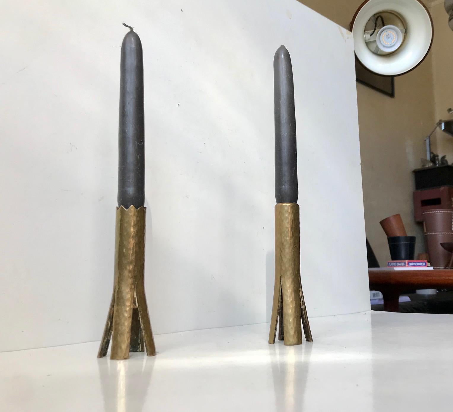 Unusual pair of hammered brass candlesticks featuring split bases and saw teeth. Made anonymously in Scandinavia, probably Finland, during the early to mid 1960s. We suspect that they are either a prototype that never came into production or made by