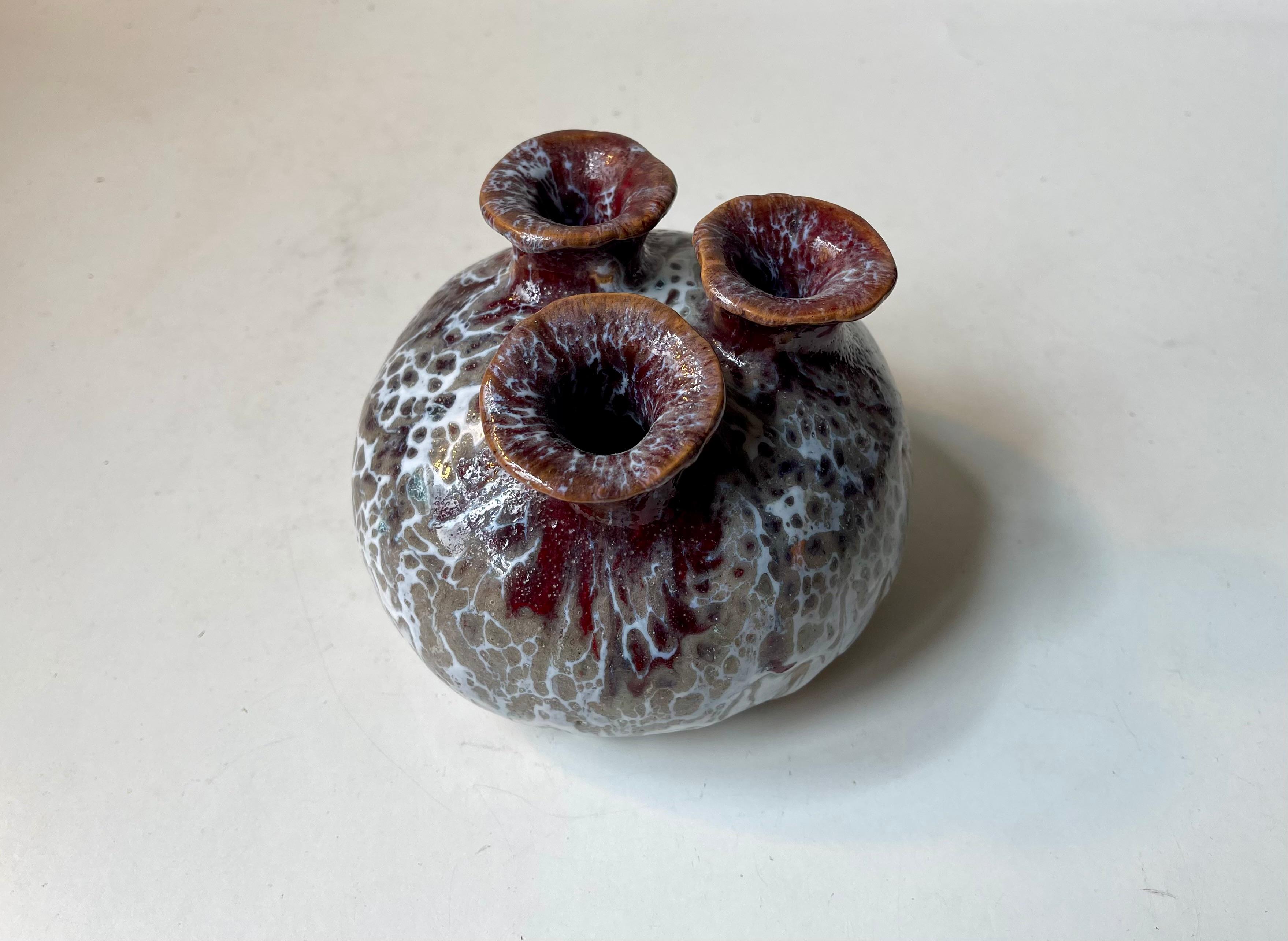 Unusual stoneware vase executed in white, brown and maroon drip glazes . It features 3 necks and can be viewed as The Scandinavian Equivalent of Japanese Ikebana. It was made anonymously during the 1970s in a style reminiscent of Jørgen Mogensen and