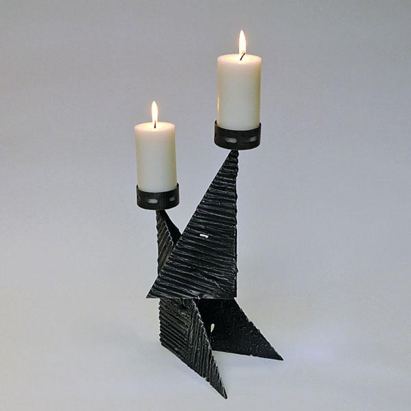 Beautiful and highly decorative brutalist metal candle holder for cube candles or larger tealights. From Scandinavia around the 1970s. The candle holder has a charcoal colored lava stone look and ageometric design with two candleholder cups of