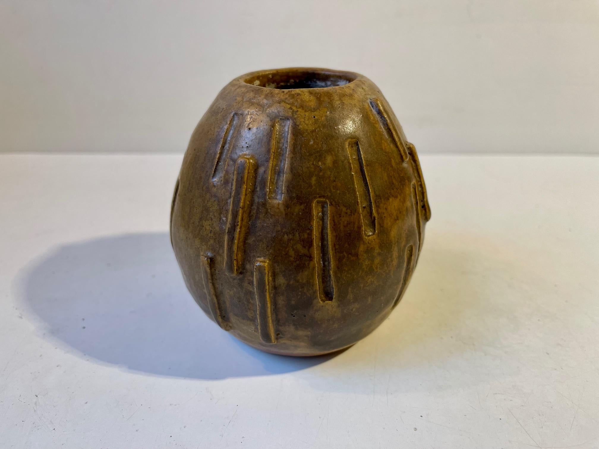 Piece unique studio art bullet shaped stoneware vase in brown hares fur glaze. Its by an unidentified Scandinavian Ceramist: EFK and is dated 1970. The style of this piece is brutalism with hints of constructivism and deconstructionism. Shown by the