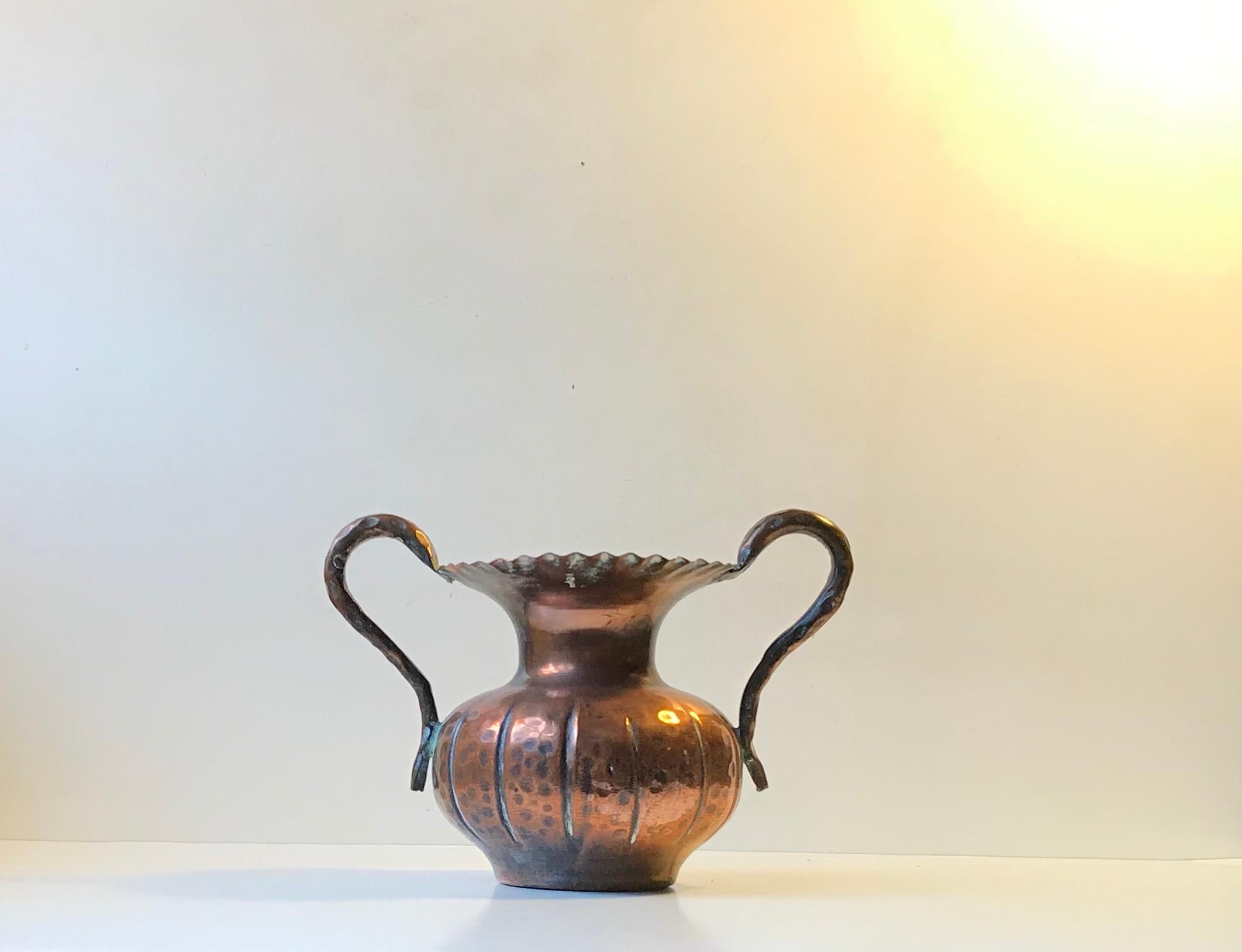 A sculptural handled vase in hand embossed copper. It displays all the right elements of Scandinavian Brutalism. Anonymous Scandinavian metal worker/artist circa 1970. It has no markings.