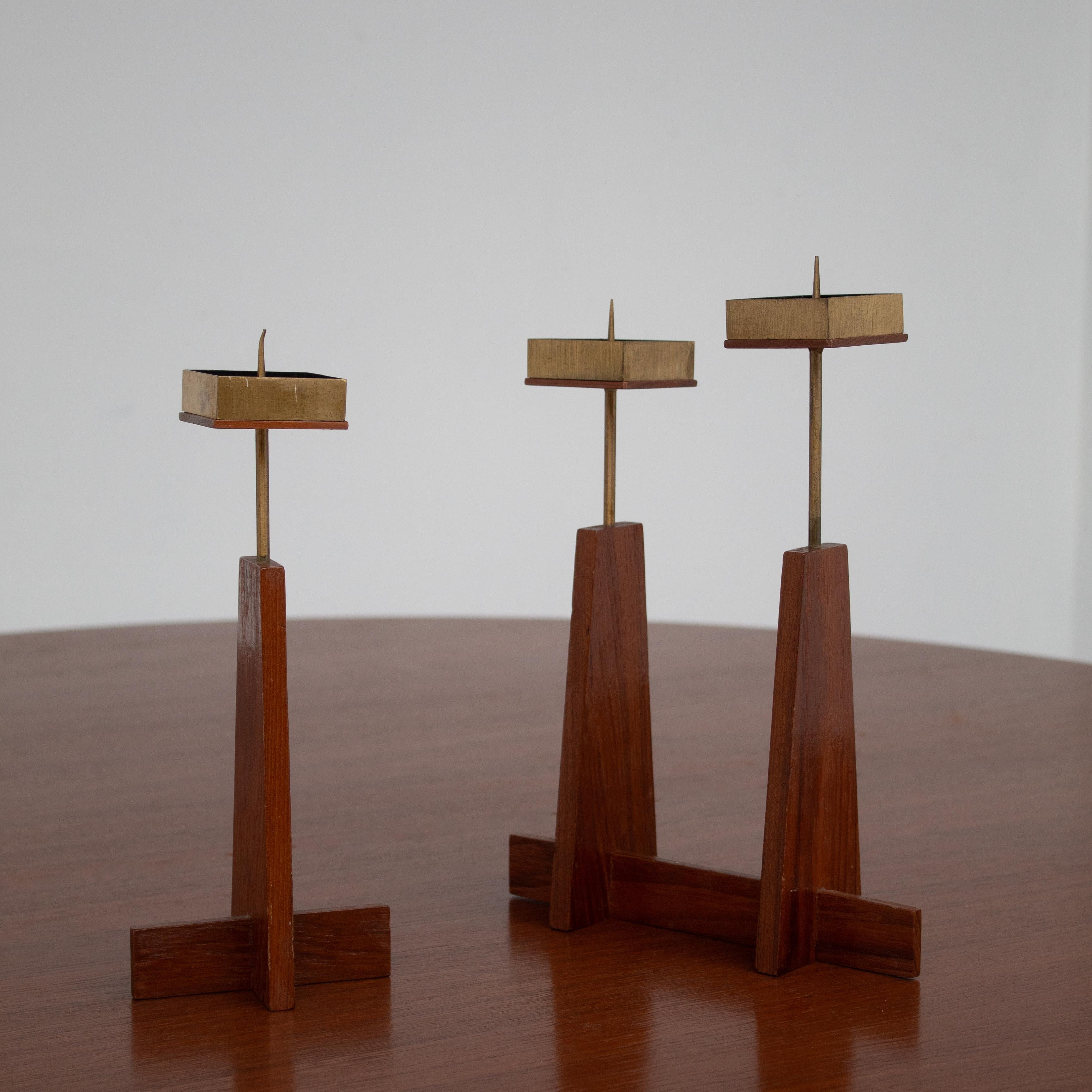 These Scandinavian candle holders are made from teak and brass, reflecting the elegance of mid-century design. The wooden base has a simple geometric form that provides balance and stability. Brass tops with pins hold candles securely in place.
The
