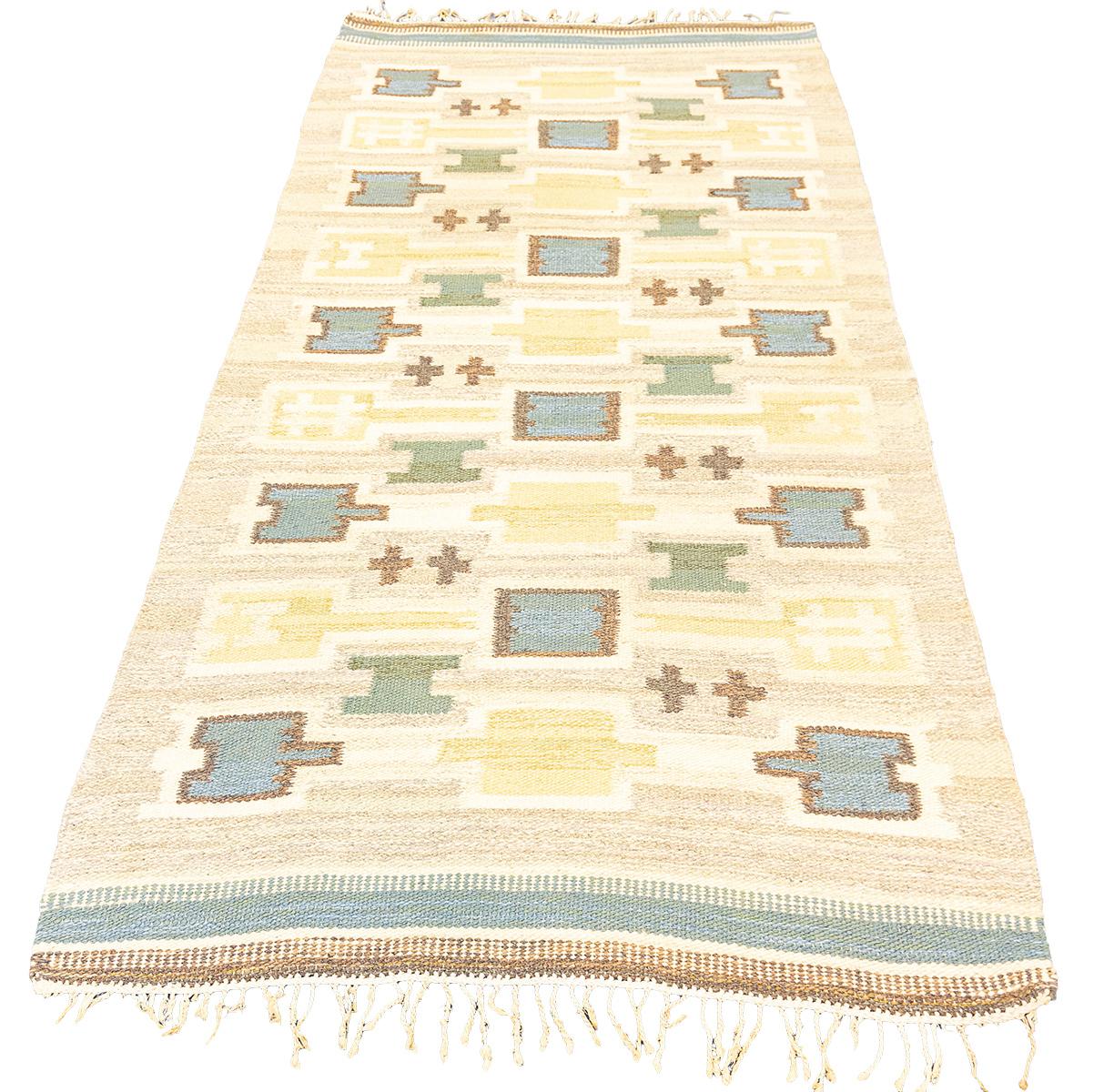 This is a Vintage Scandinavian Rollakan Swedish Rug with a cross motif design contrasting very will with Soft Beige, Blue, and Gold colors. This flat-weave rug is a true masterpiece, embodying a unique blend of elements that make it both special and