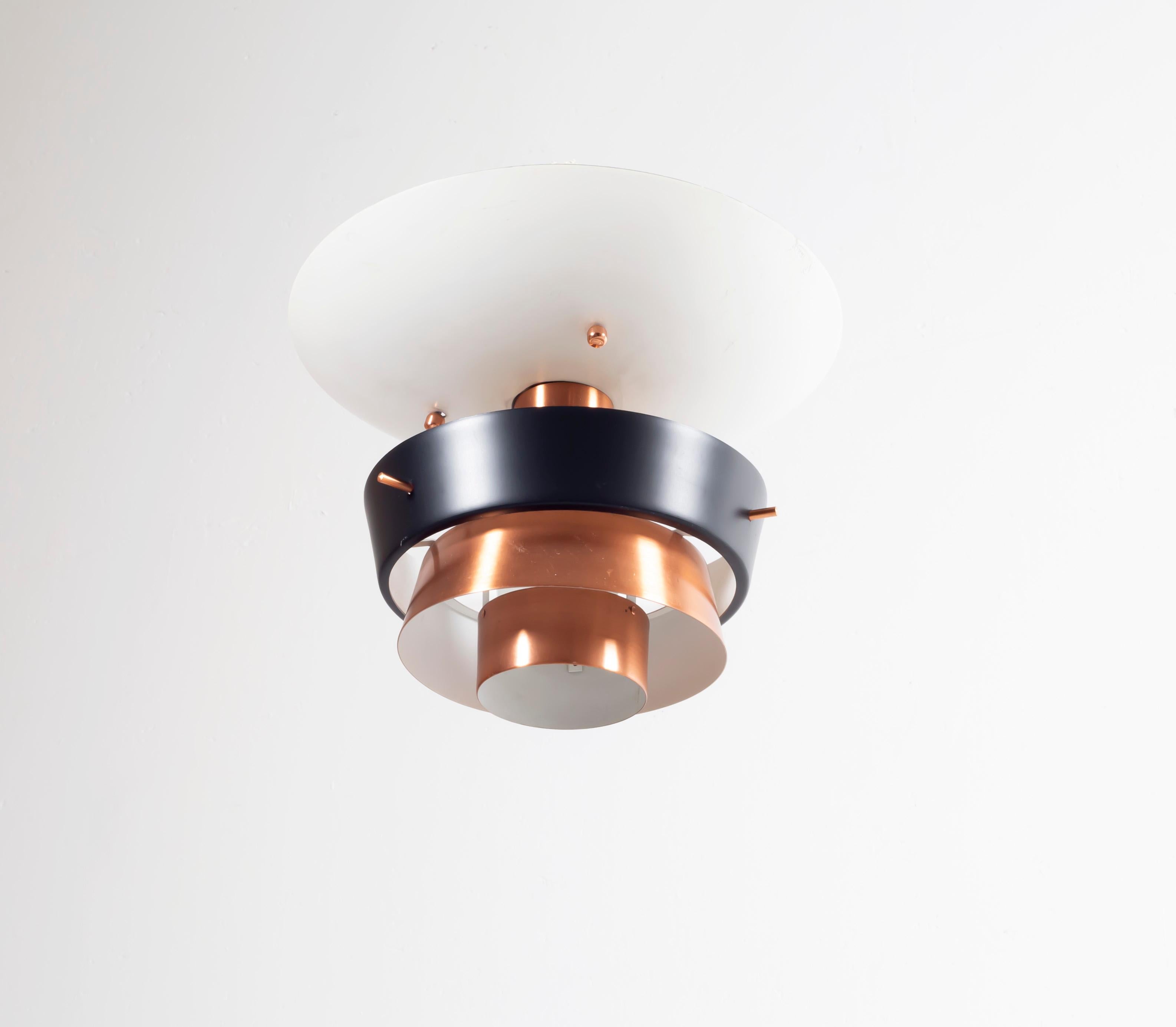 Wonderful and well-made ceiling light on a copper and steel frame. Designed and made in Norway by Tr&Co (T. Røste), circa 1960s second half. The lamp is fully working and in fair vintage condition.