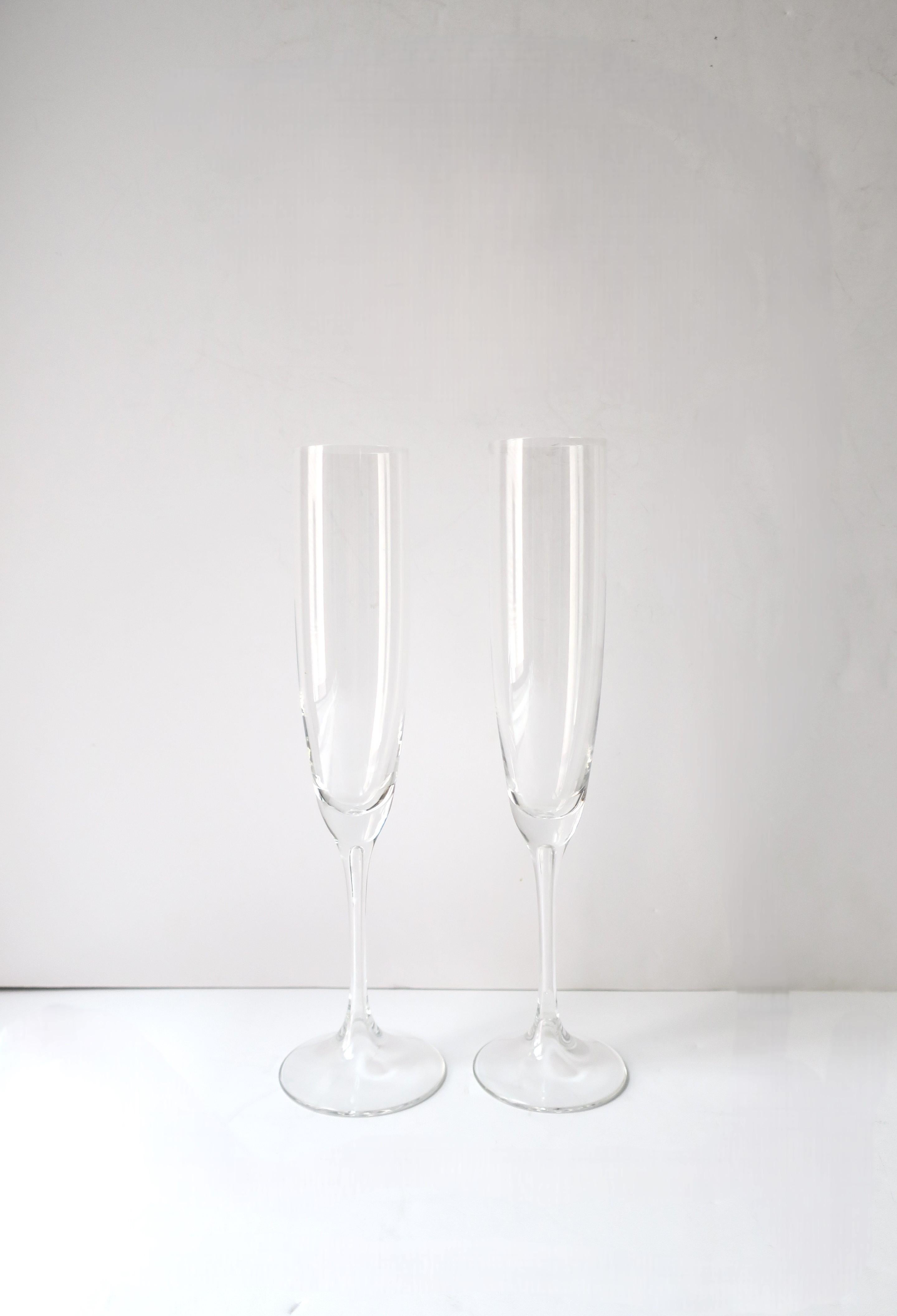 An elegant pair of crystal Champagne flutes glasses, Scandinavian Modern, circa 20th century, Scandinavia. A beautiful set with 'hollow' stem detail, shown in close-up image, last image. No chips noted. Measurment: 10.07