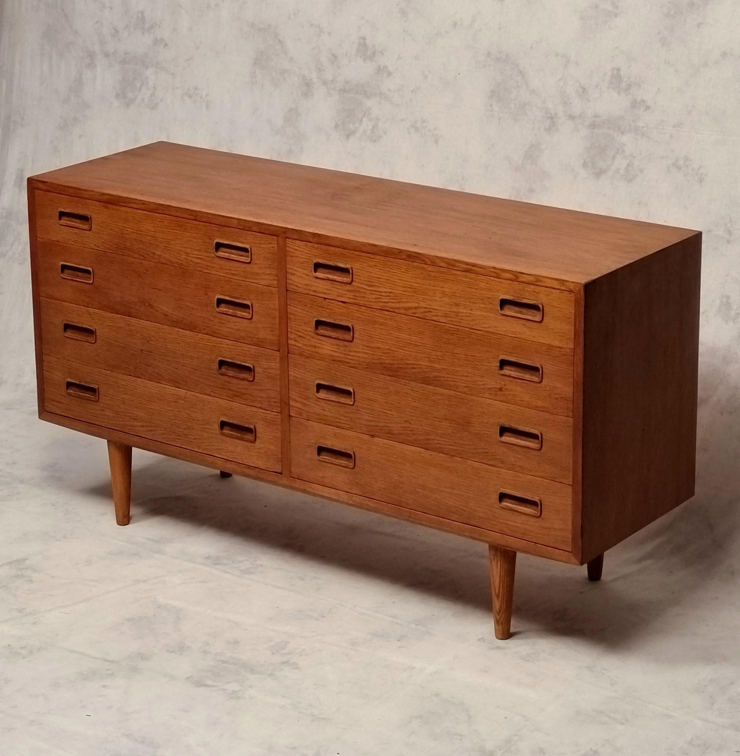 Scandinavian double chest of drawers by designer Carlo Jensen produced by Poul Hundevad and his company Hundevad & Co. Pretty light oak furniture from the 1960s, mid century modern, which has two rows of four drawers. It also rests on four oak legs.