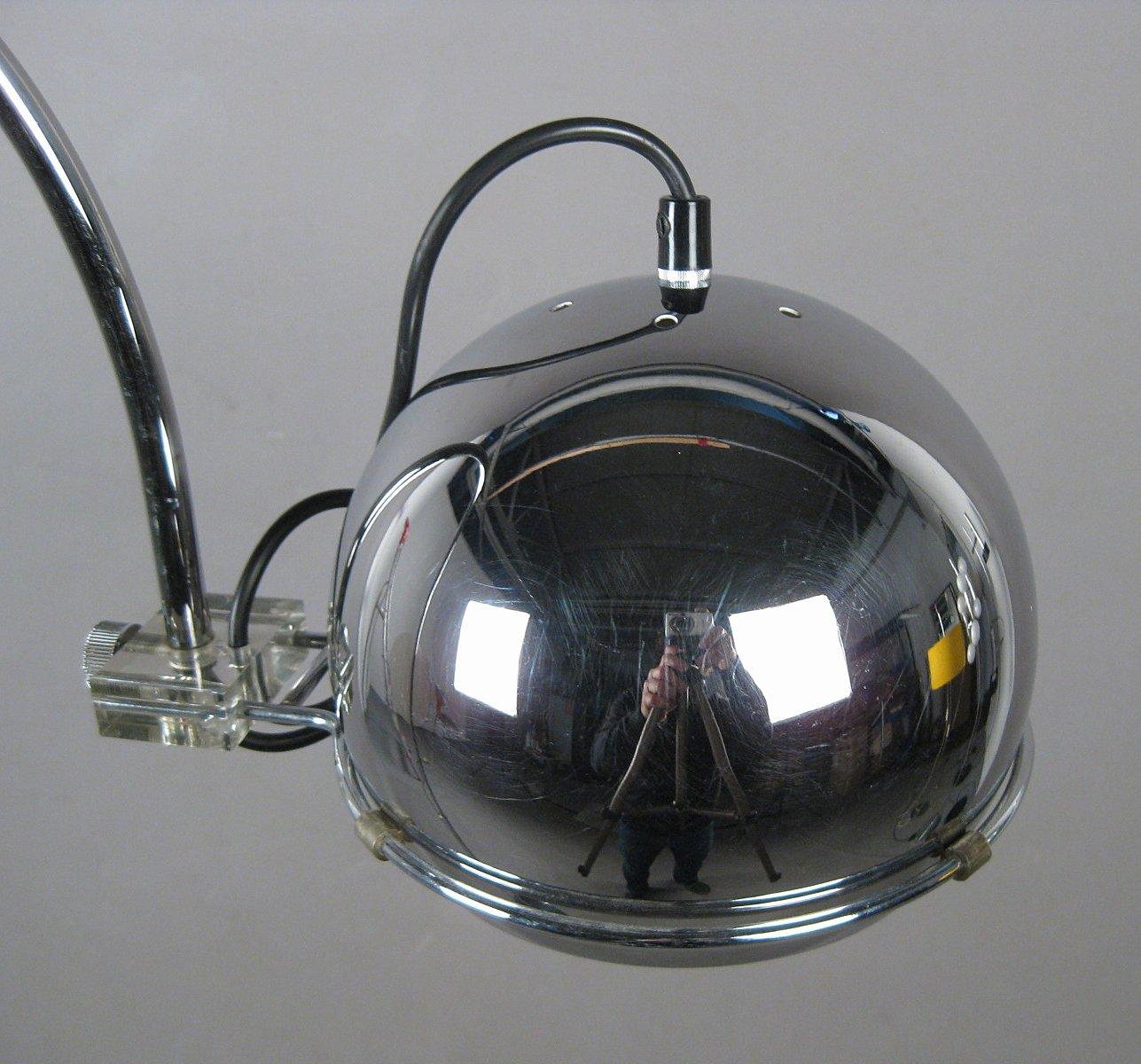 Small chrome ball bow light of the 1970s. Adjustable chromed metal construction, loose recessed spherical reflector that can be turned up or down. Slight signs of wear commensurate with age.