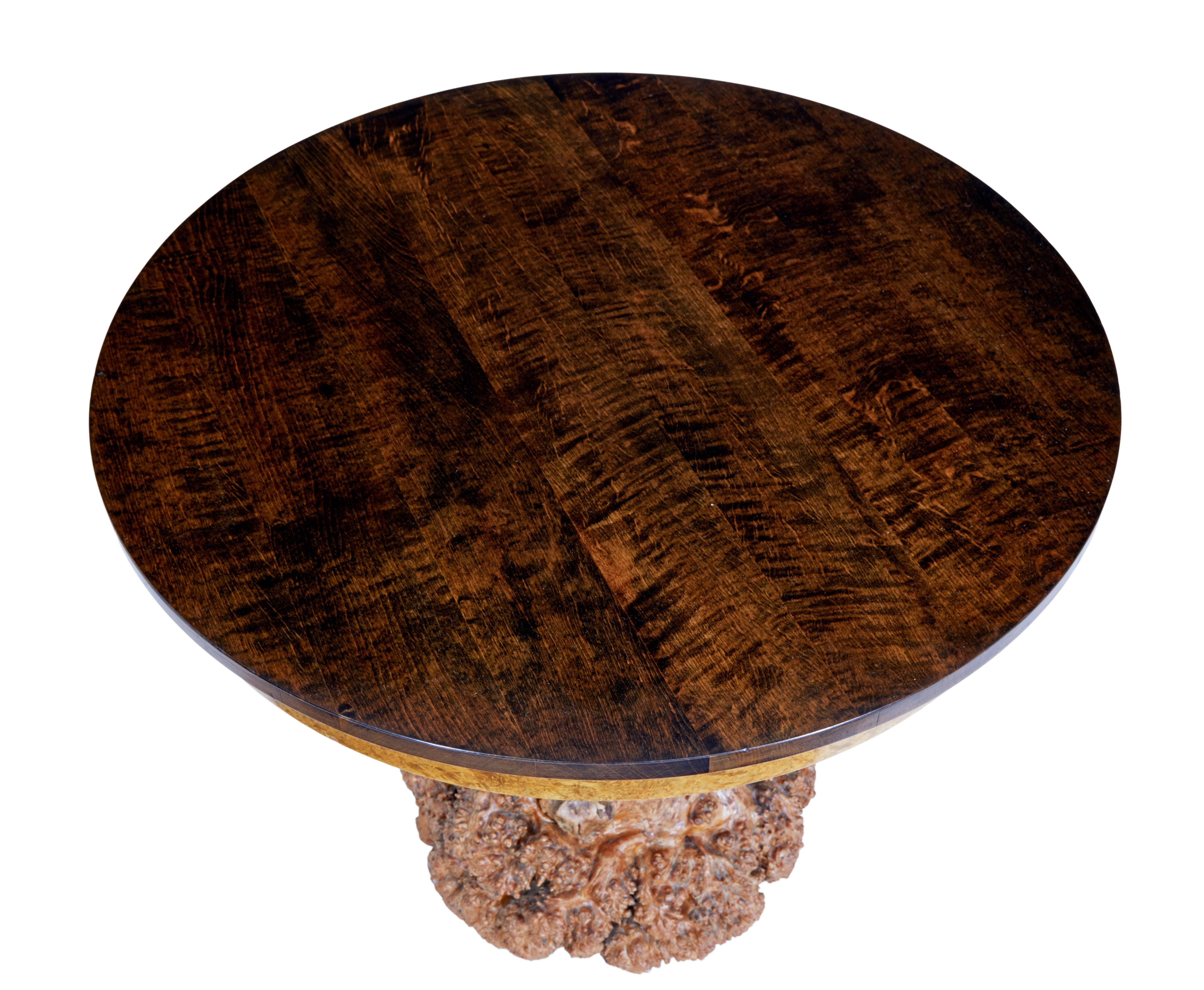 Unusual circular occasional table with burr root base circa 1930.

Recently re-polished dark stained circular birch top with burr frieze, standing on burr root base which has been adapted to work as a base.

Rich golden colour.

Minor surface marks,