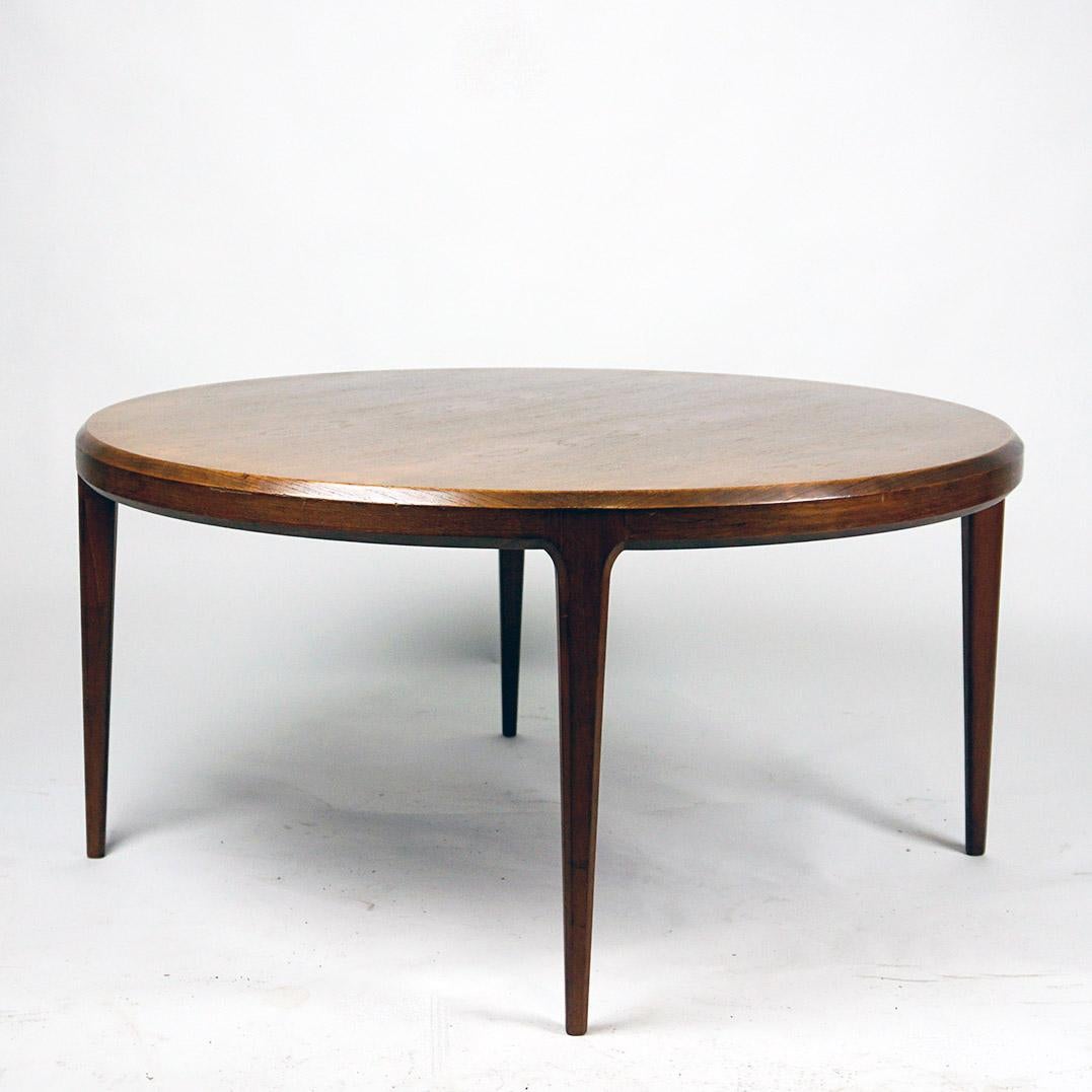 This beautiful circular Scandinavian Modern Rosewood Coffee Table was designed by Johannes Andersen in the 1960s and produced by CFC Silkeborg, Denmark, in the 1960s.
It features a Puristic shape with a circular Top and four legs.  On the underside