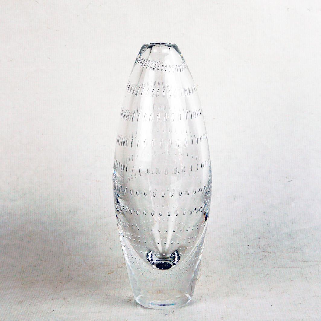 This elegant and sophisticated vase was realized by the esteemed midcentury Swedish glass studio, Orrefors, circa 1960.
It features a charming controlled bubble design.  
It is made of clear crystal and shows rows of air bubbles, ranging in small