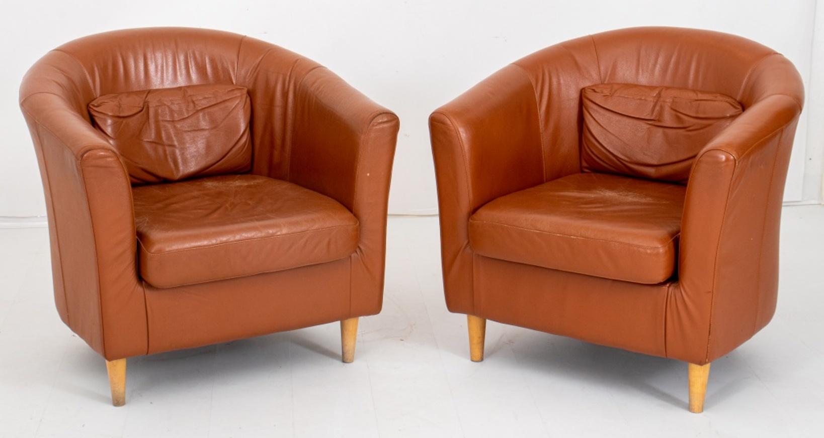 Pair of Scandinavian club chairs, 2, with leather upholstery (worn), with curved back and arms above a drop in cushion on four tapering columnar legs.

Dimensions: 29