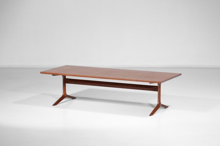 Scandinavian coffee table by Danish designers Peter Hvidt and Orla Molgard dating from the 60s. Solid teak structure, with a metal insert on the legs. Very nice work on the central beam and the typical Scandinavian legs (see pictures). Excellent