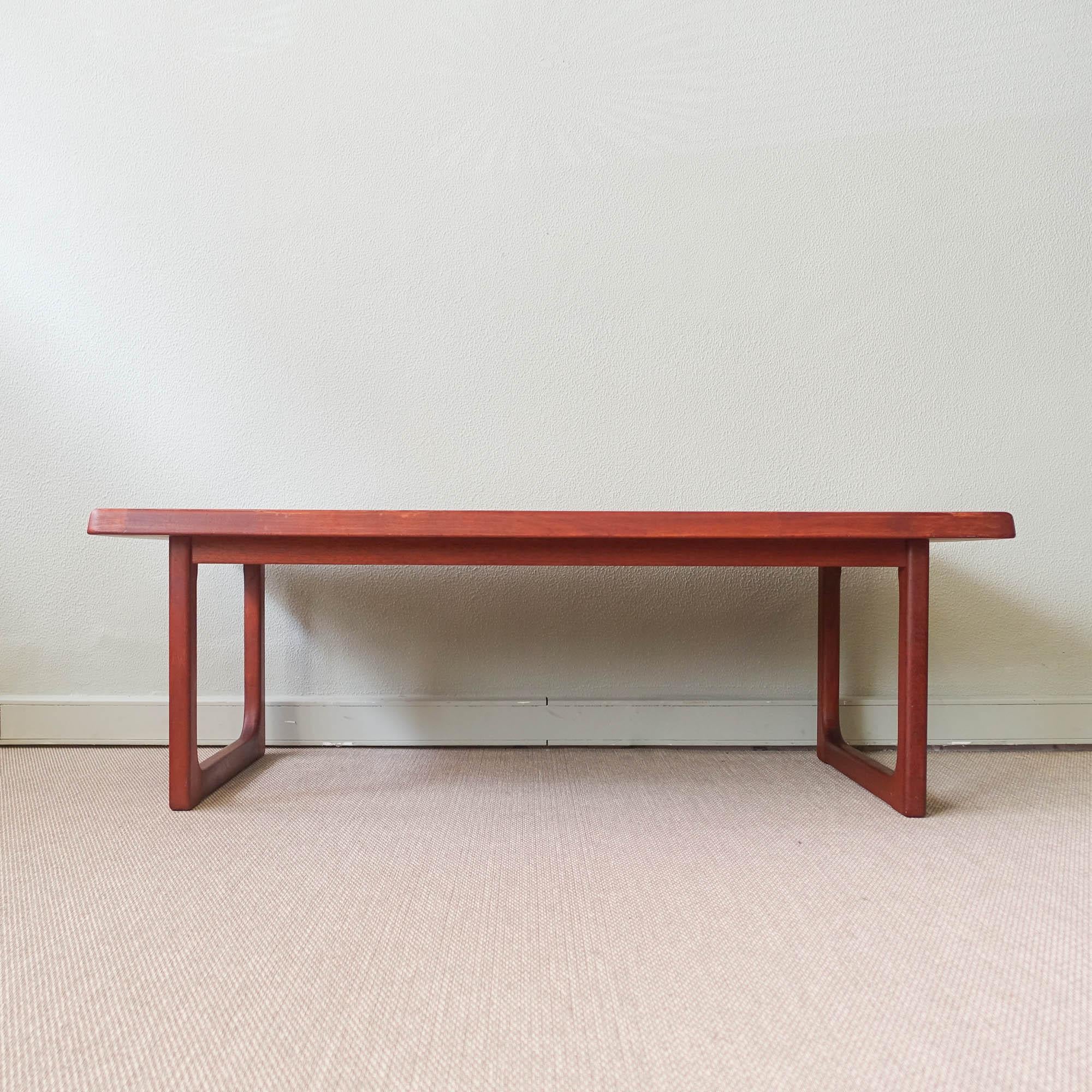 This coffee table was designed by Niels Bach and produced by Randers Denmark in Denmark, during the 1970's. It is made from solid teak with a rectangular table top with rounded corners and skid feet. All joinery has been reworked in the very