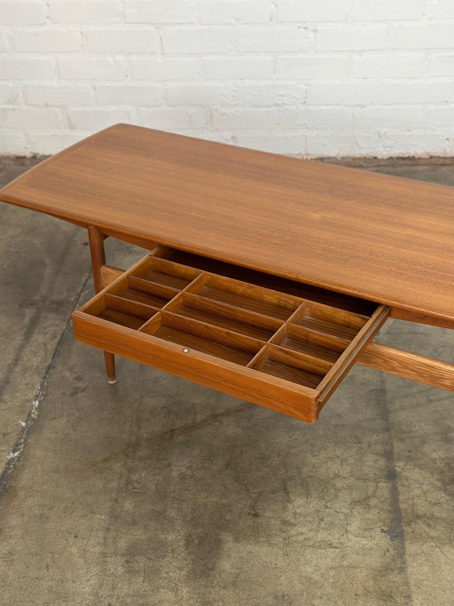 W60 D21 H21

Restored 1960s coffee table in overall great condition. Item was fully refinished and reinforced by our in house Carpentry team. Coffee table over nice teak construction with solid teak end caps one storage drawer with dividers. Minor