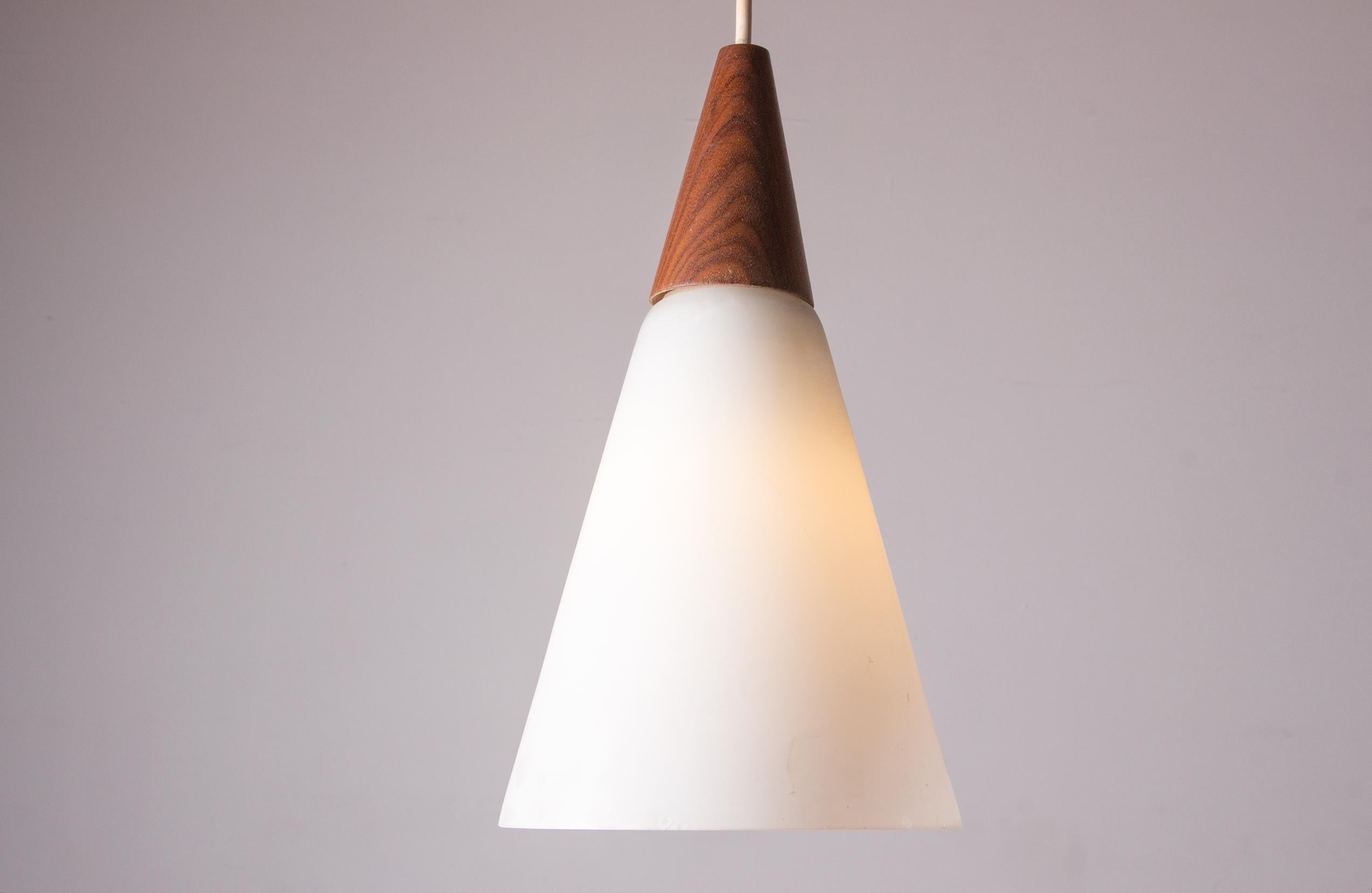 Superb pendant light made from a teak support extended by a conical opaline. Sober and elegant design for beautiful lighting