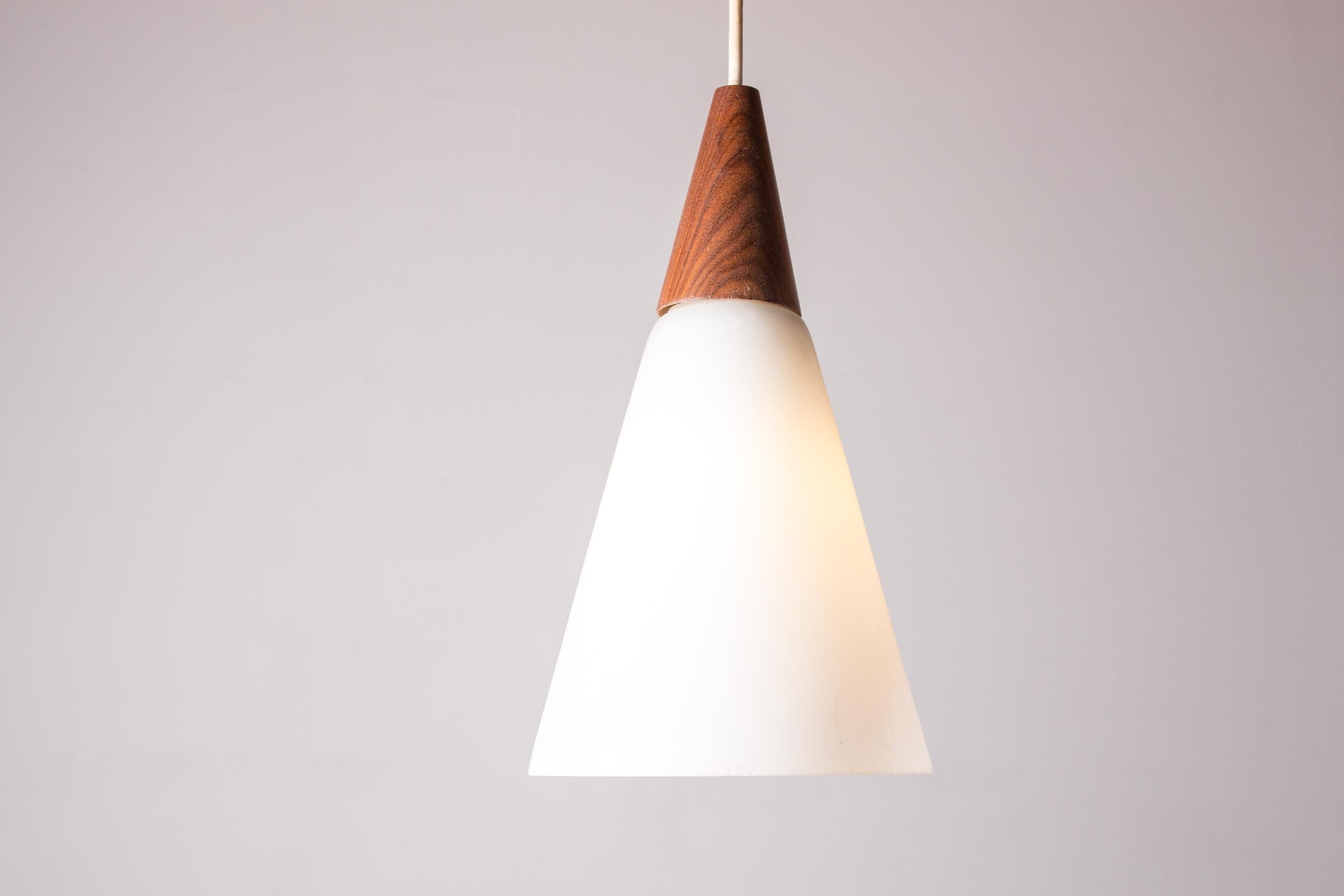 Scandinavian Modern Scandinavian conical pendant light in teak and Opaline by Louis Kalff.