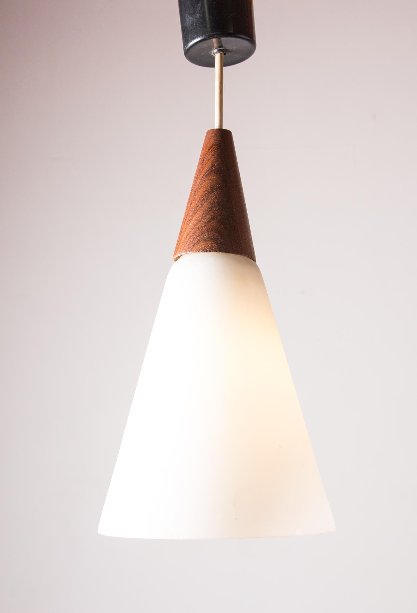 Dutch Scandinavian conical pendant light in teak and Opaline by Louis Kalff.