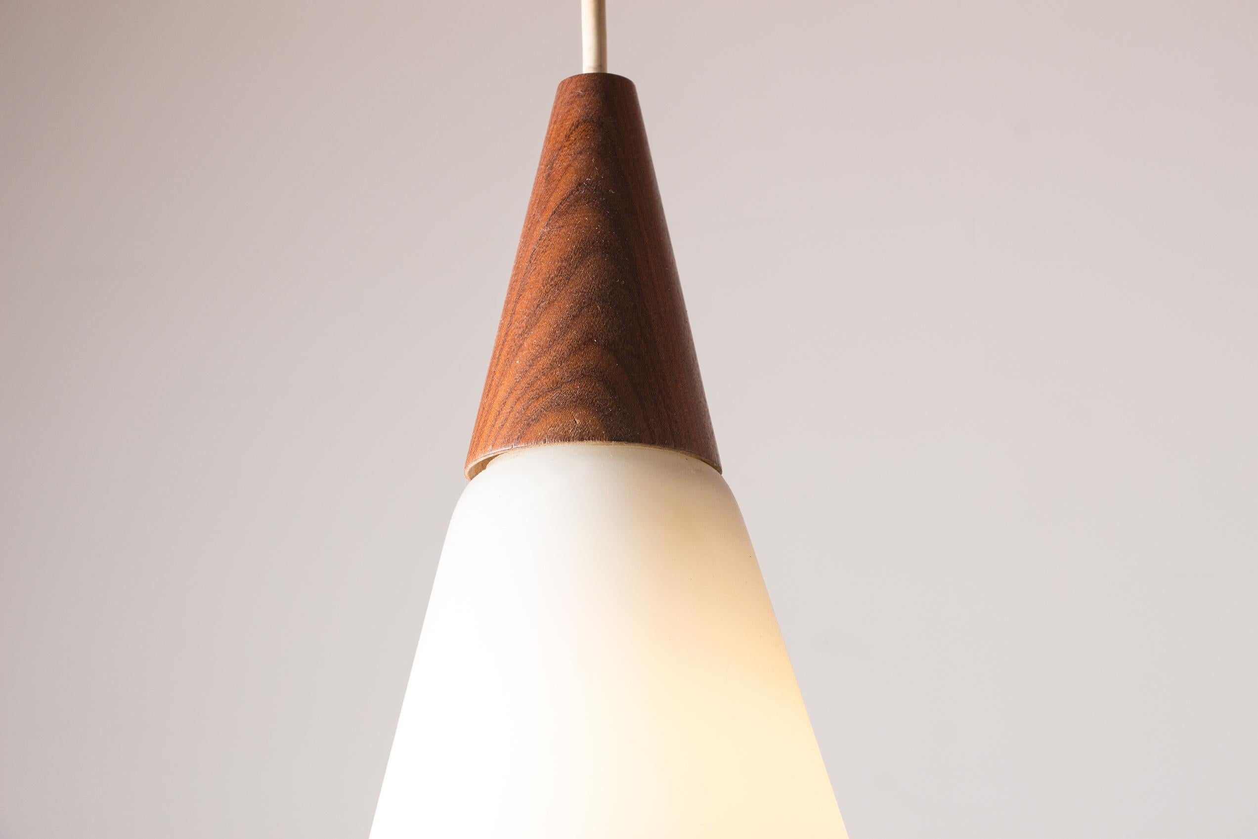 Scandinavian conical pendant light in teak and Opaline by Louis Kalff. In Excellent Condition In JOINVILLE-LE-PONT, FR