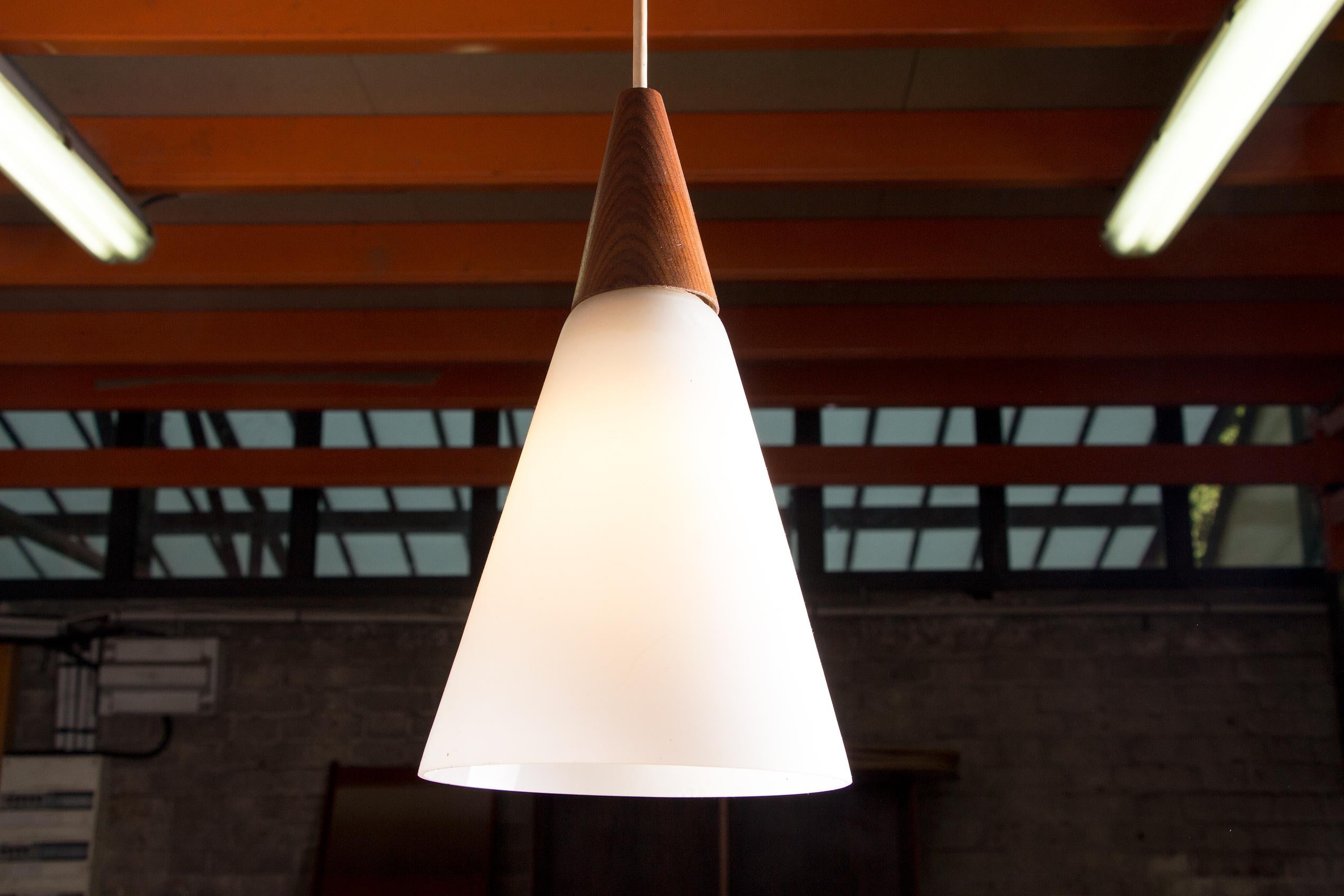 Scandinavian conical pendant light in teak and Opaline by Louis Kalff. 2