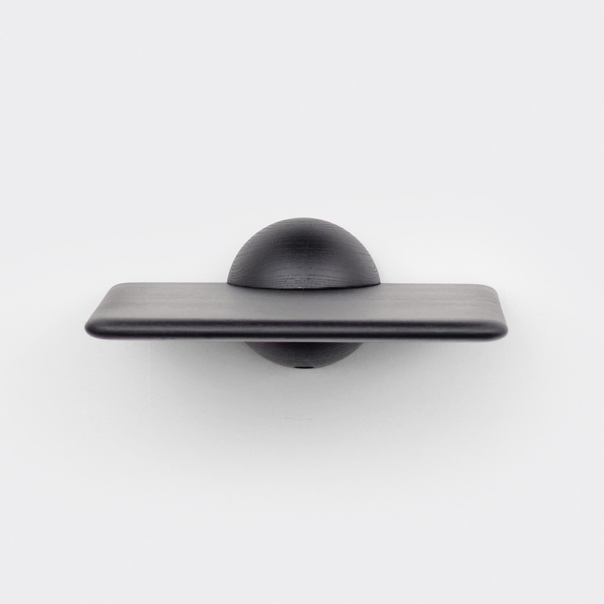 The half sphere holding the plane contributes to a bold yet minimal look that works well in several different spaces and environments. Whether used as a shelf for an extraordinary object, as a bedside table or as a small bar table it's present with